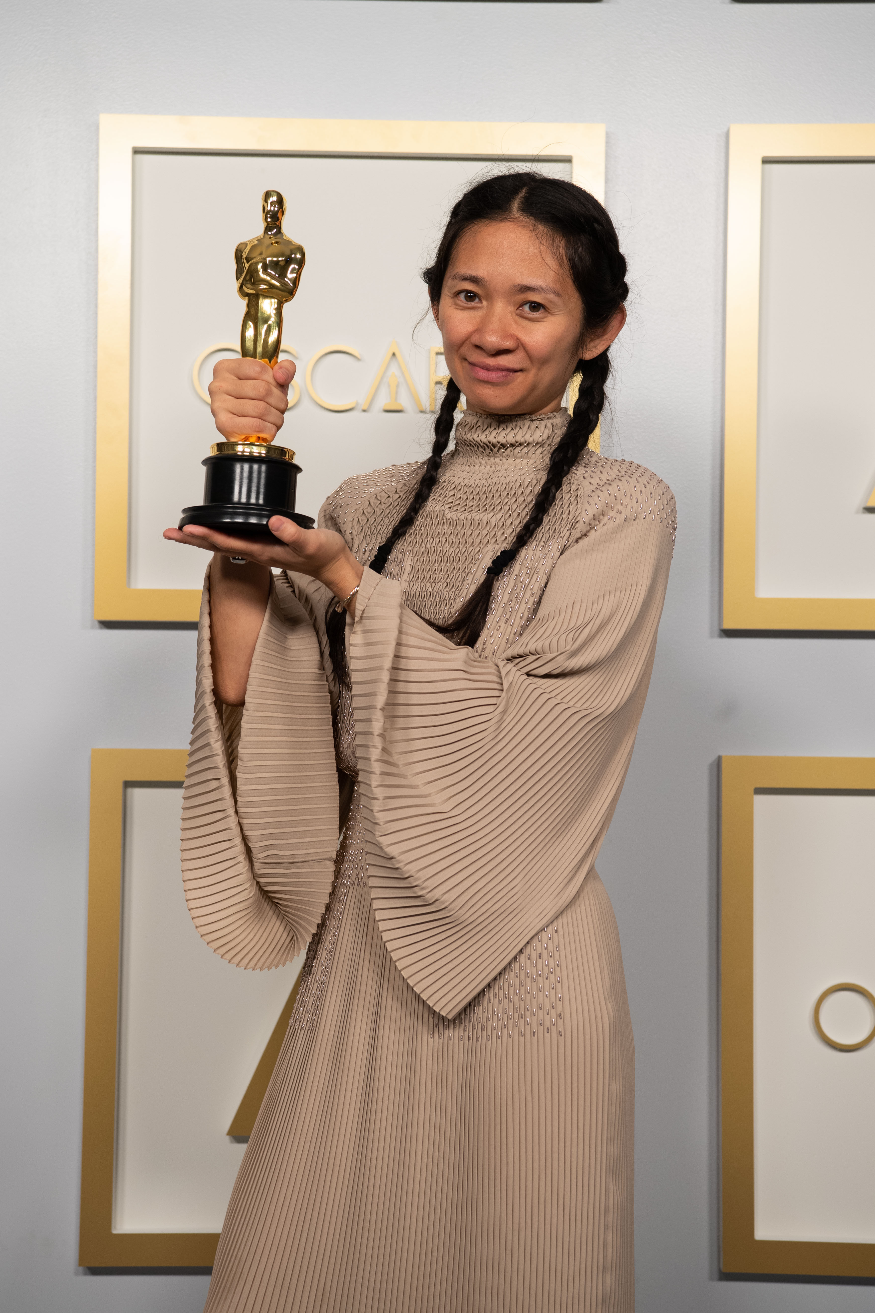 Chinese director and producer Chloe Zhao poses with one of her Oscars awards for best picture and director for Nomadland, at the press room of the 93rd Oscars Academy Awards at Union Station in Los Angeles on April 25, 2021. Photo: AMPAS/PA Media/DPA