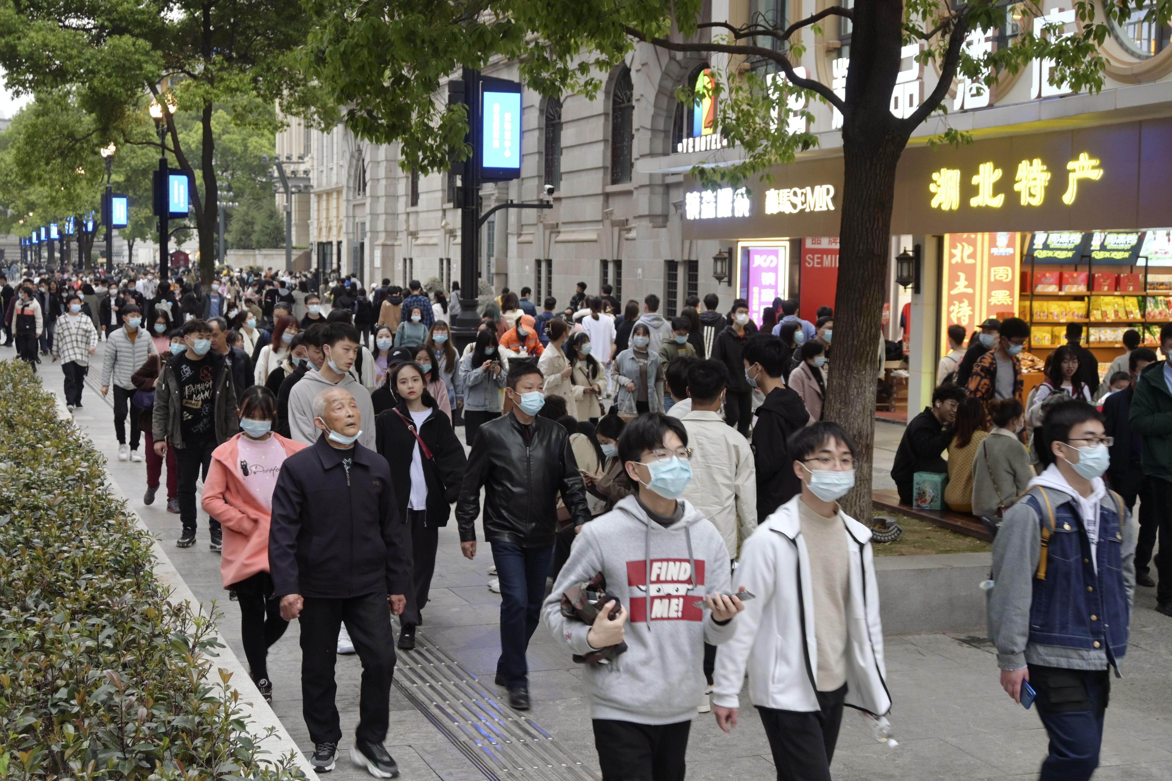 A crowded shopping street in Wuhan on April 4, 2021, about a year after the world’s first coronavirus lockdown was lifted in the city. China is now expected to overtake the US as the top economy by 2028, thanks in part to its handling of the pandemic. Photo: Kyodo