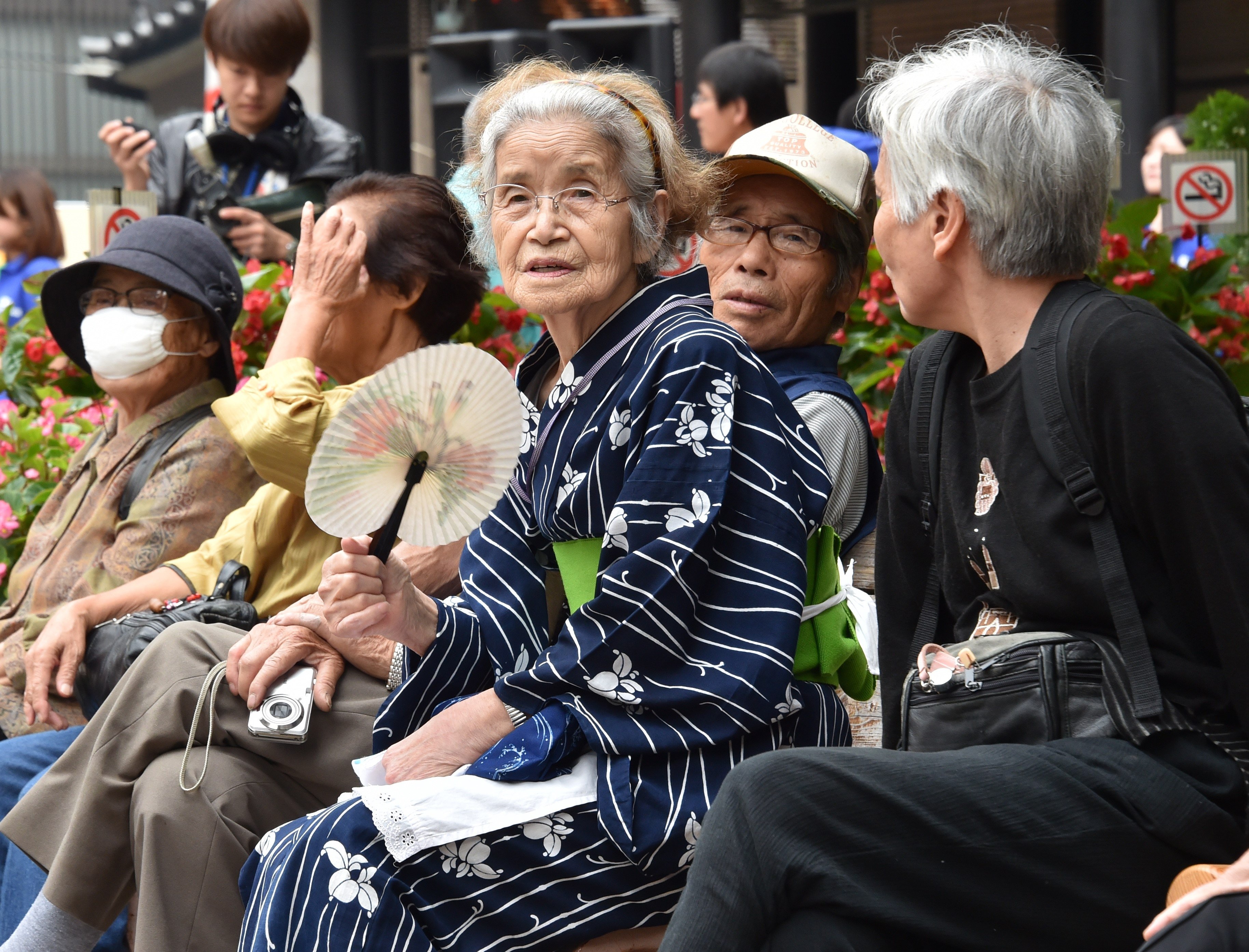 Elderly residents rest at the grounds of a temple in Tokyo. Photo: AFP