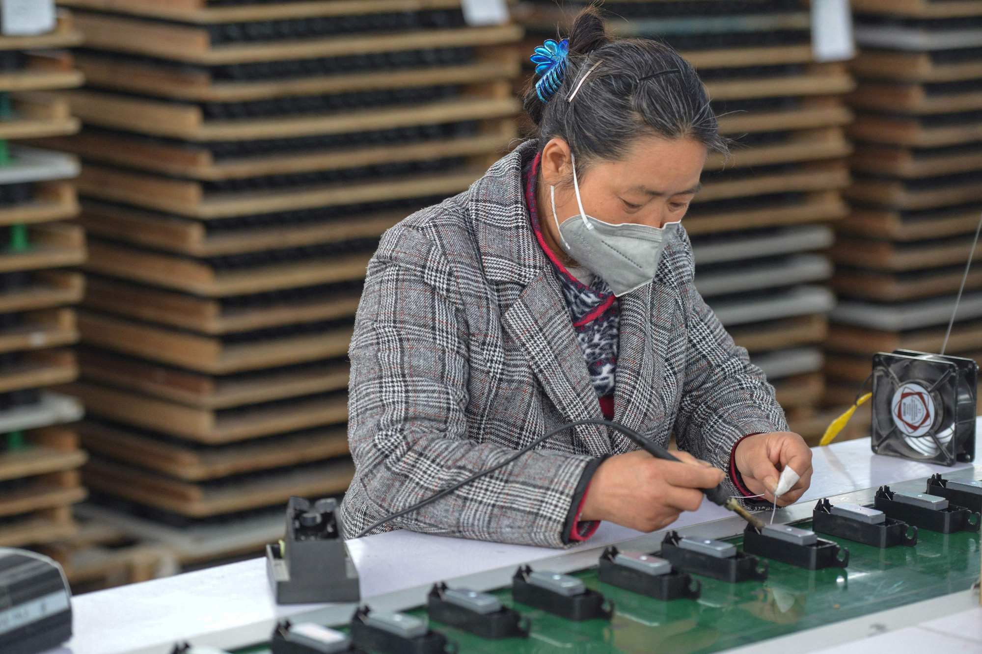 A worker assembles speakers in a factory in Fuyang, China. Photo: AFP