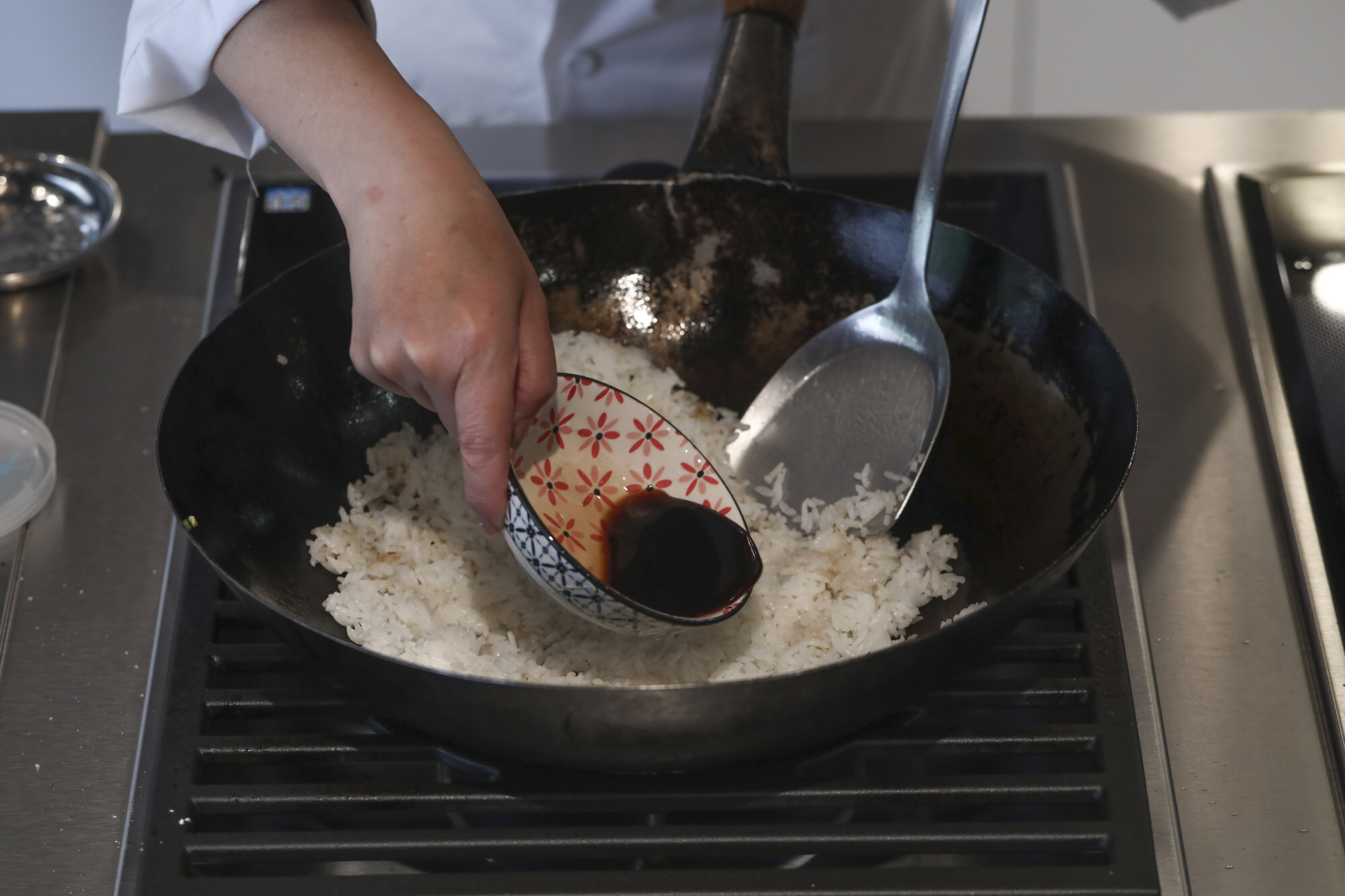 Start stir-frying the rice until it’s hot, then add some of the goose drippings. Photo: Jonathan Wong