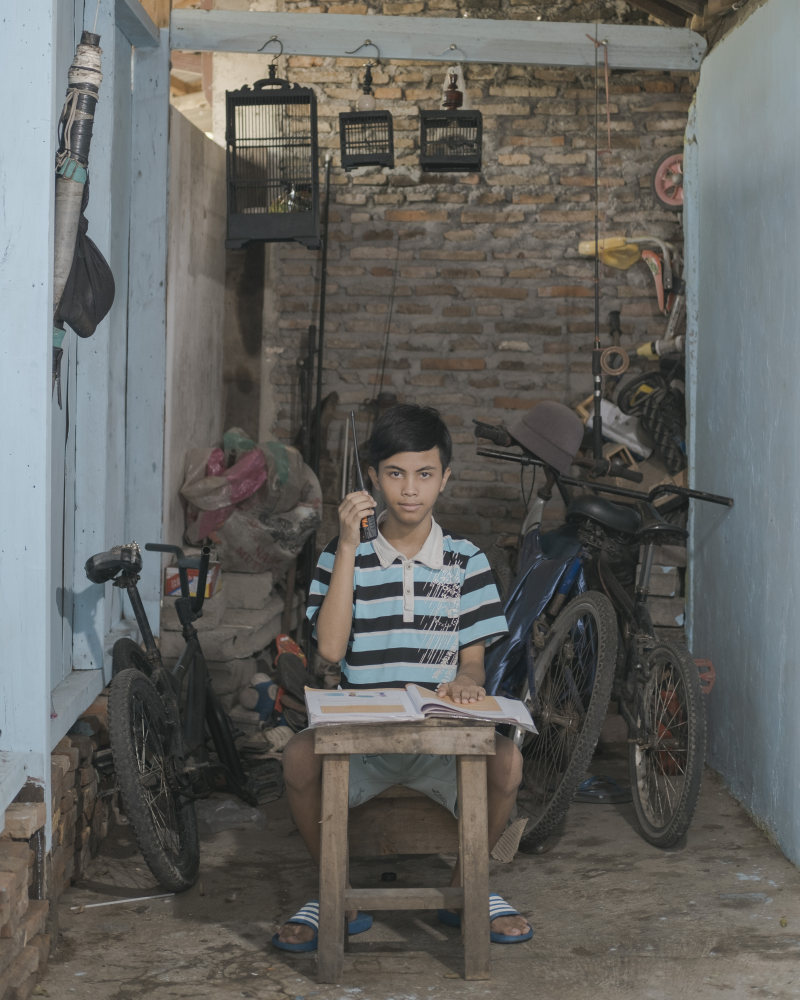 Yoga Putra Pratama, 12: “Studying using a walkie-talkie helped me to not buy expensive internet packages. The money can be used by our family for other purposes.” Photo: Agoes Rudianto
