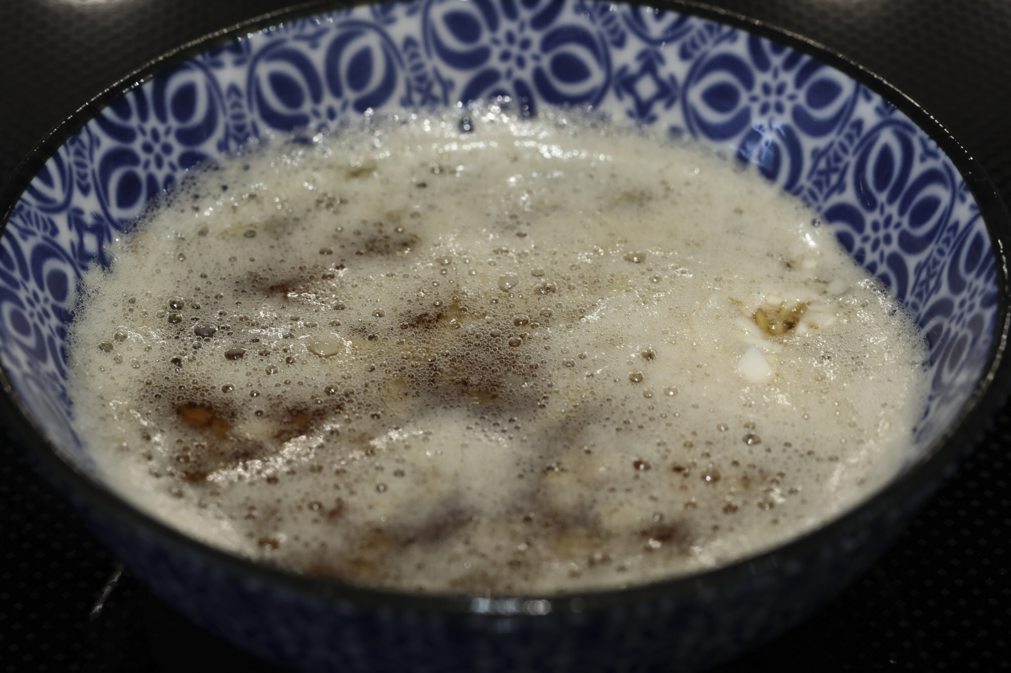 Pour the hot oil over the garlic and ginger. Photo: Jonathan Wong