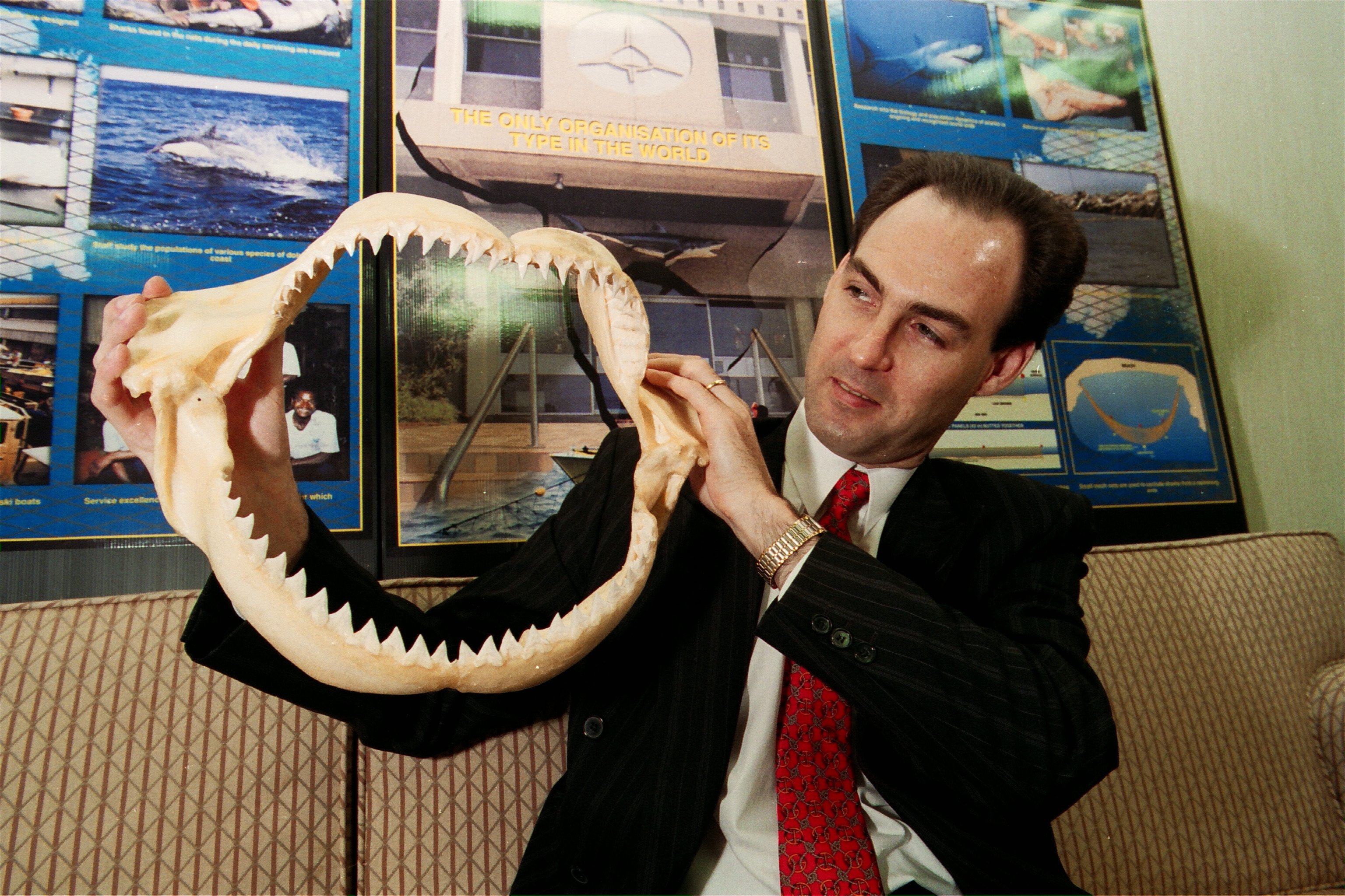 South African consul-general Michael Farr holding shark jaws at the centre of the Natal Sharks Board. The Board’s nets are used in Hong Kong to keep sharks away. Photo: CWH
