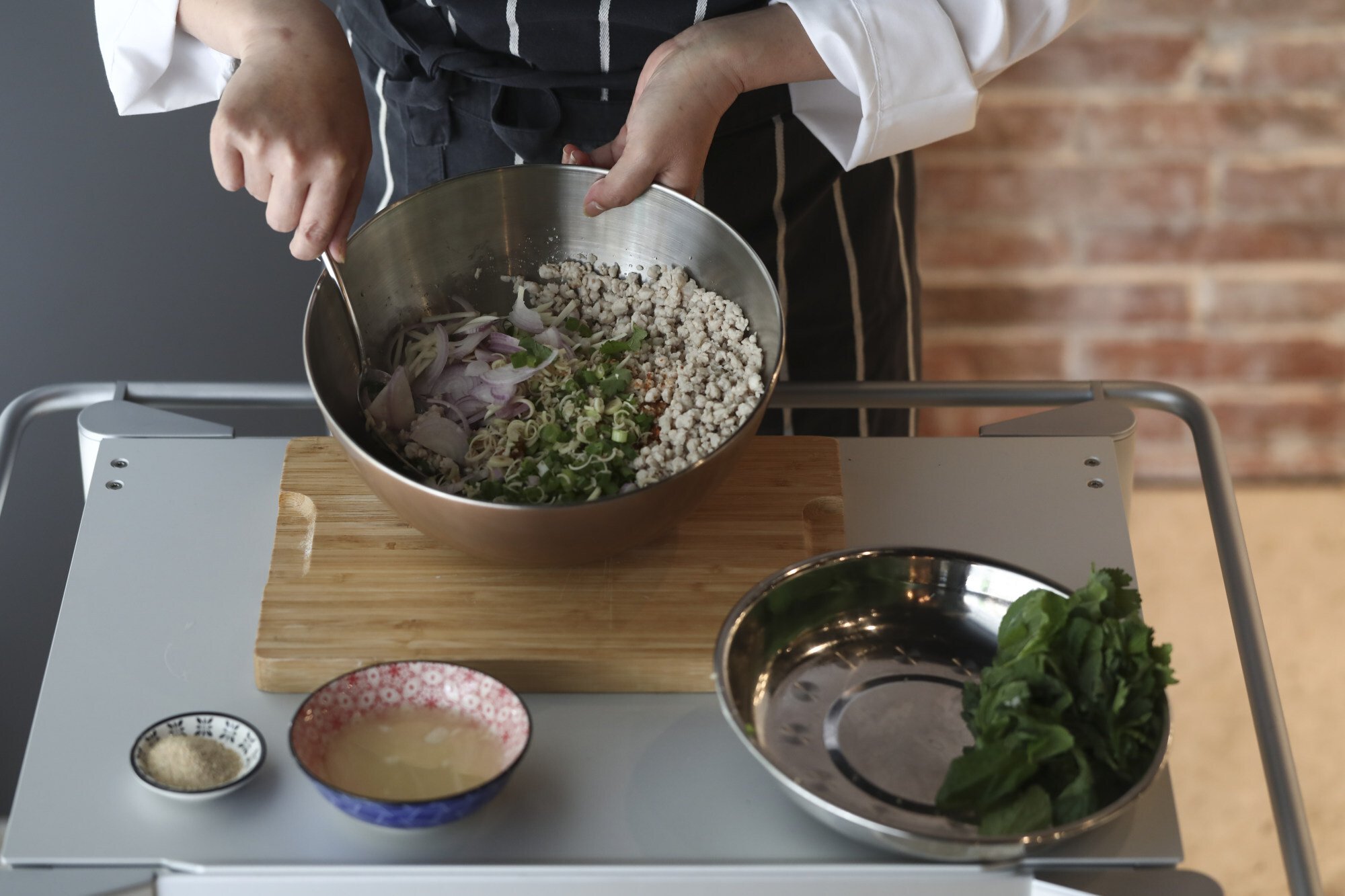 Stir well before adding the lime juice, fresh herbs and toasted rice powder. Photo: Jonathan Wong