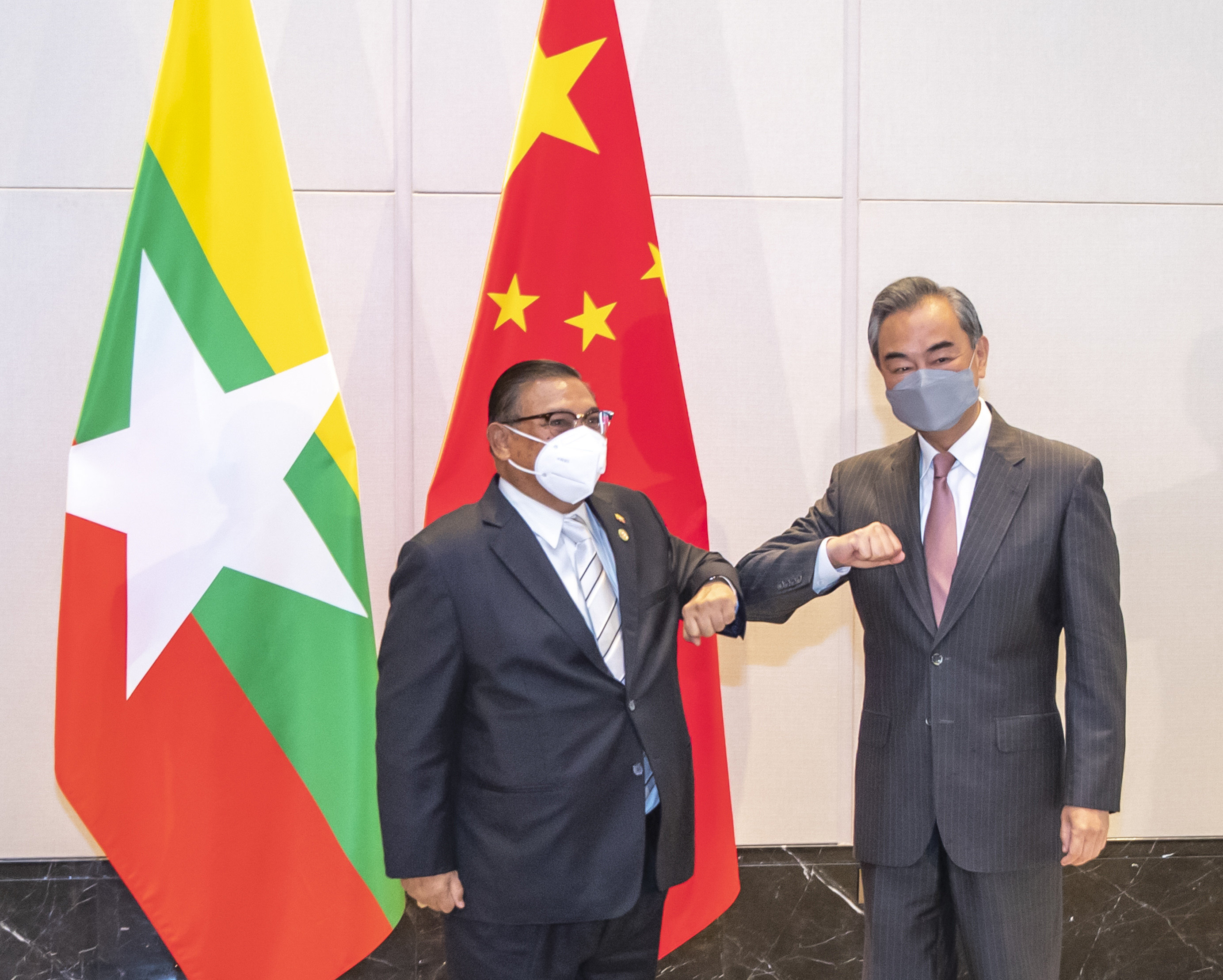 China’s Foreign Minister Wang Yi (right) bumps elbows with junta representative Wunna Maung Lwin at a June 8 meeting marking the 30th anniversary of formal relations between China and Asean. Photo: Xinhua