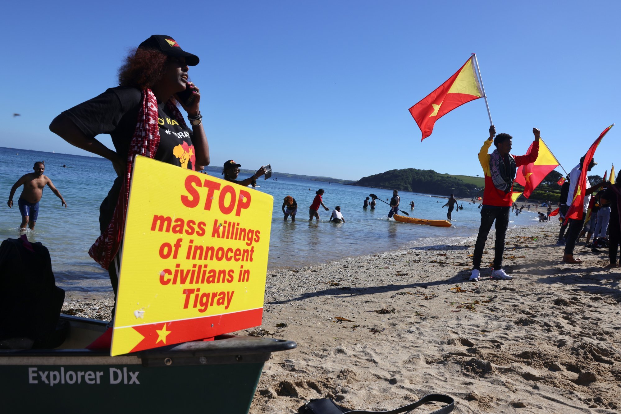 Demonstrators hold Tigray’s flags as they gather by the sea in Falmouth, Cornwall, UK during the G7 summit. Photo: Reuters