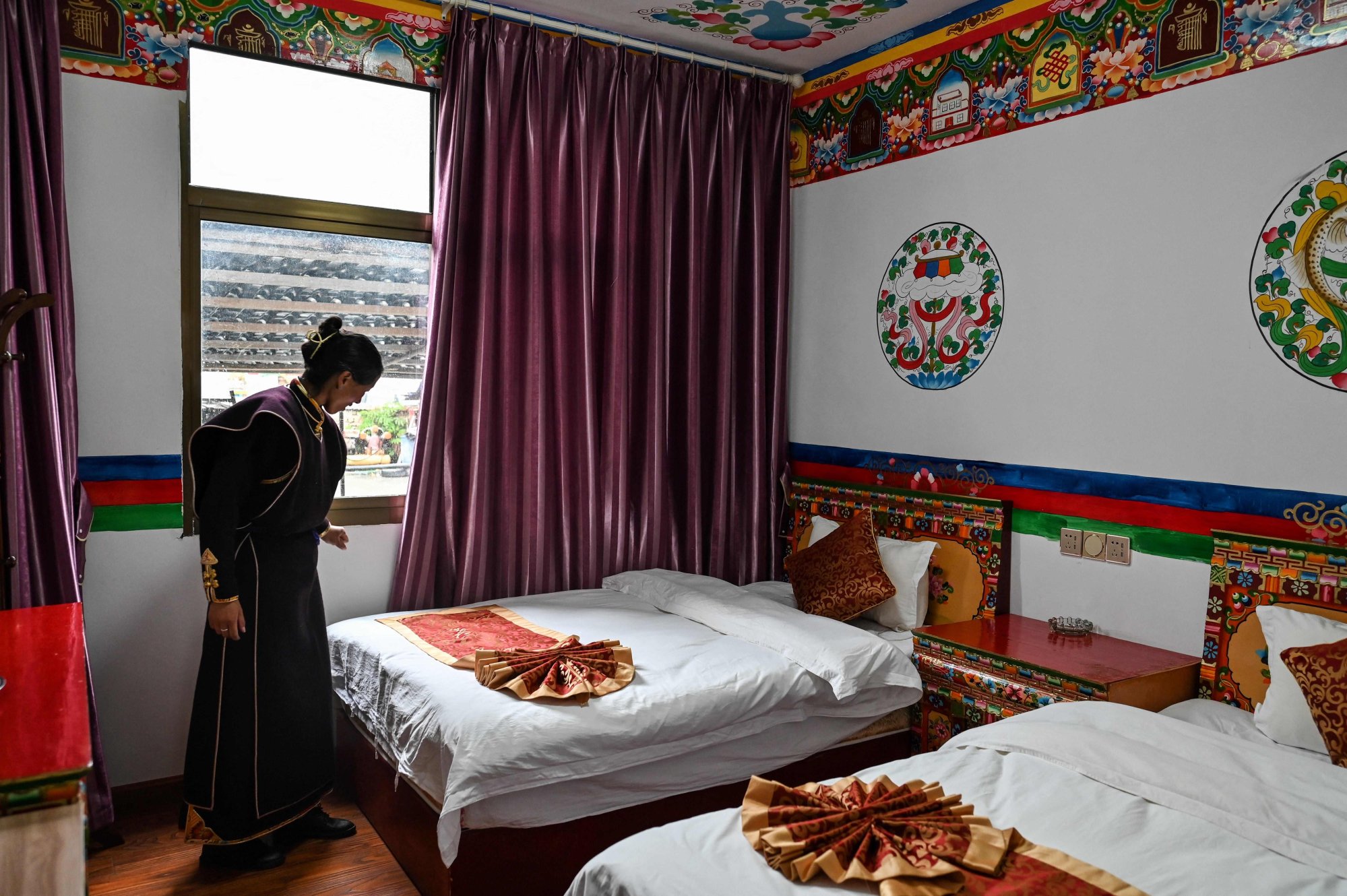 Cangjie checks on a room in her hotel in the village of Tashigang in the city of Nyingtri in Tibet. Photo: AFP