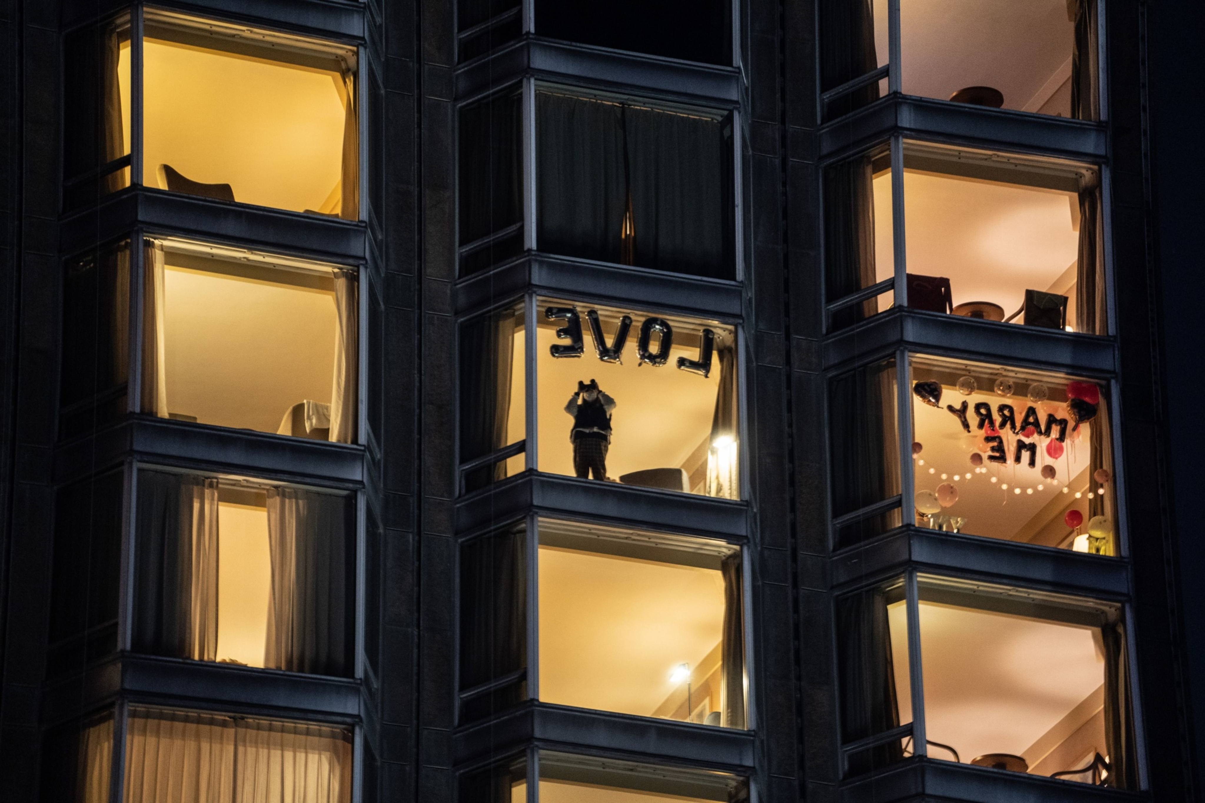 A guest looks out from a hotel window on New Year’s Eve last year in Tsim Sha Tsui. Photo: Bloomberg
