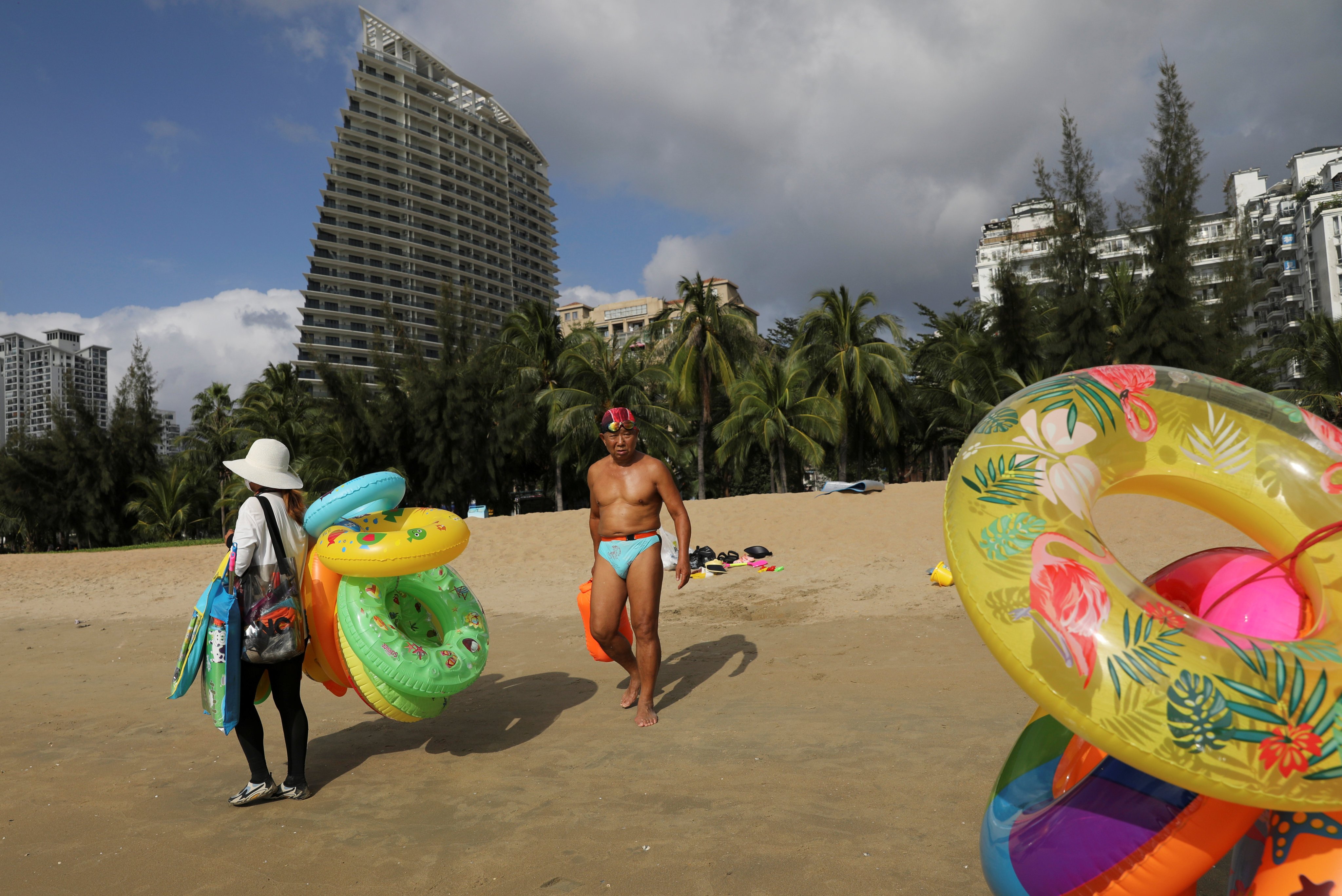 A vendor selling swimming accessories on Sanya Bay beach in Hainan province, China. Photo: Reuters