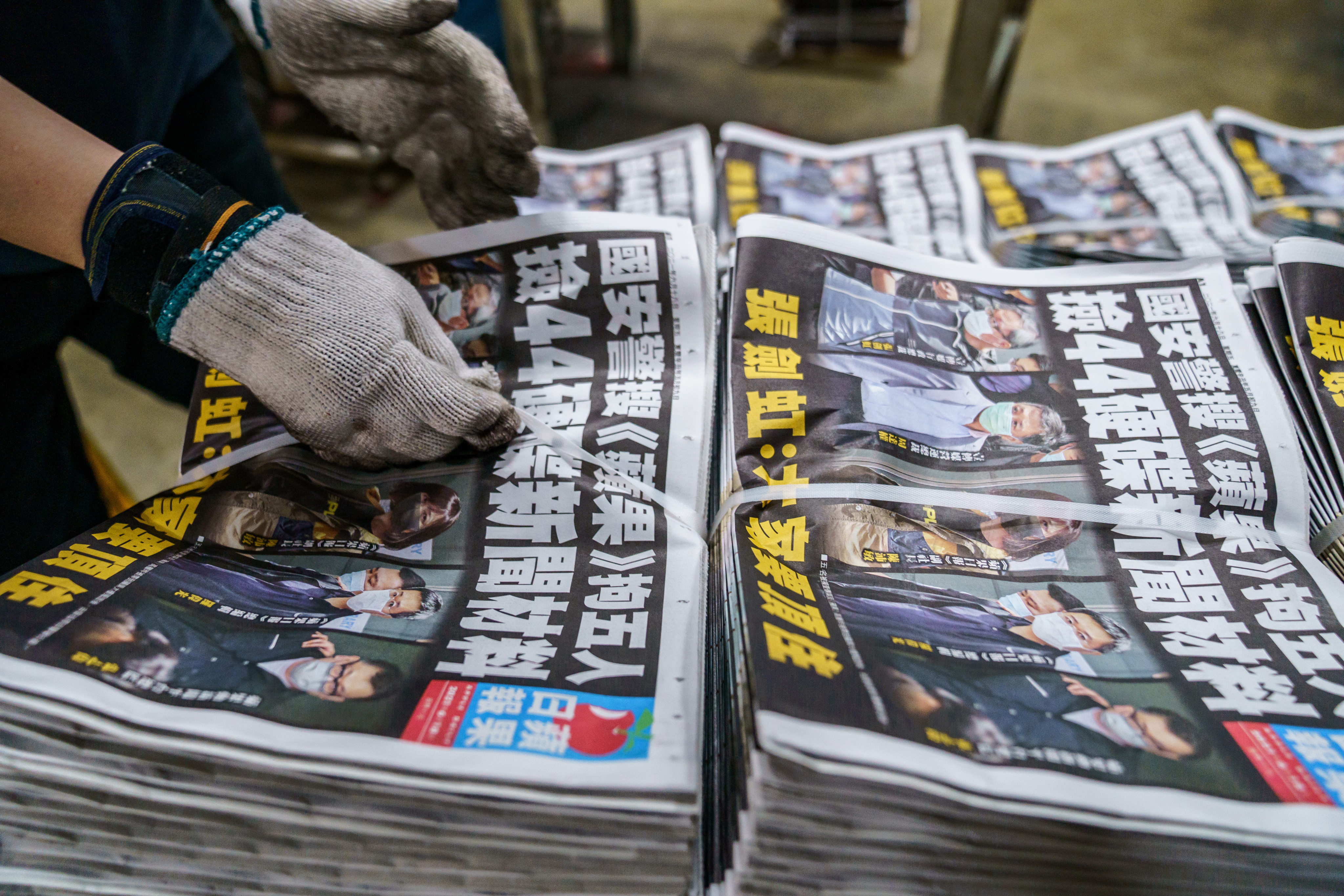 Bundles of the Apple Daily newspapers are prepared for distribution in Hong Kong on Friday. Photo: Bloomberg