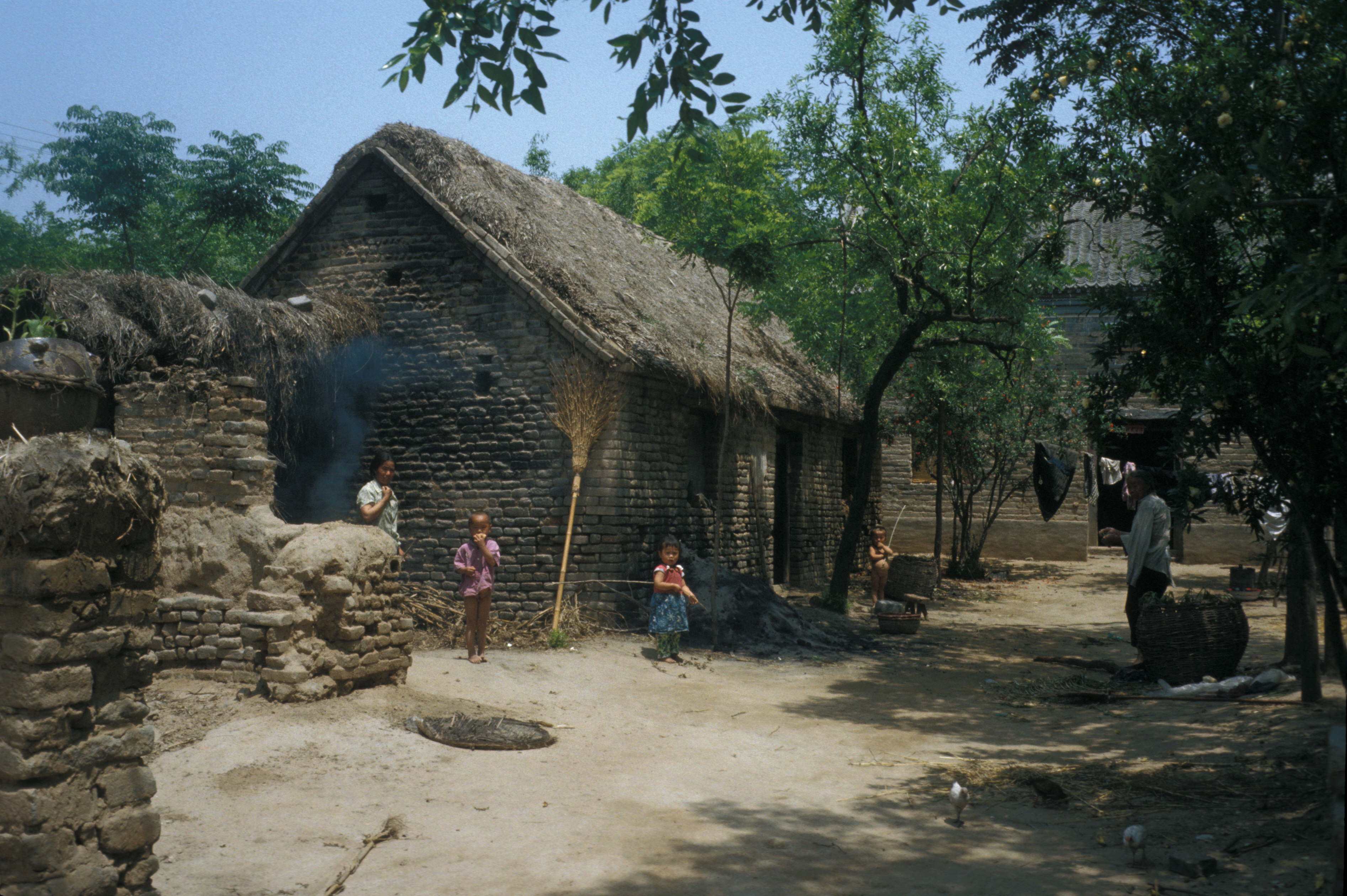 Children and adults stand outside a house in a village in China’s Henan province circa 1984. Photo: Roger Viollet via Getty Images