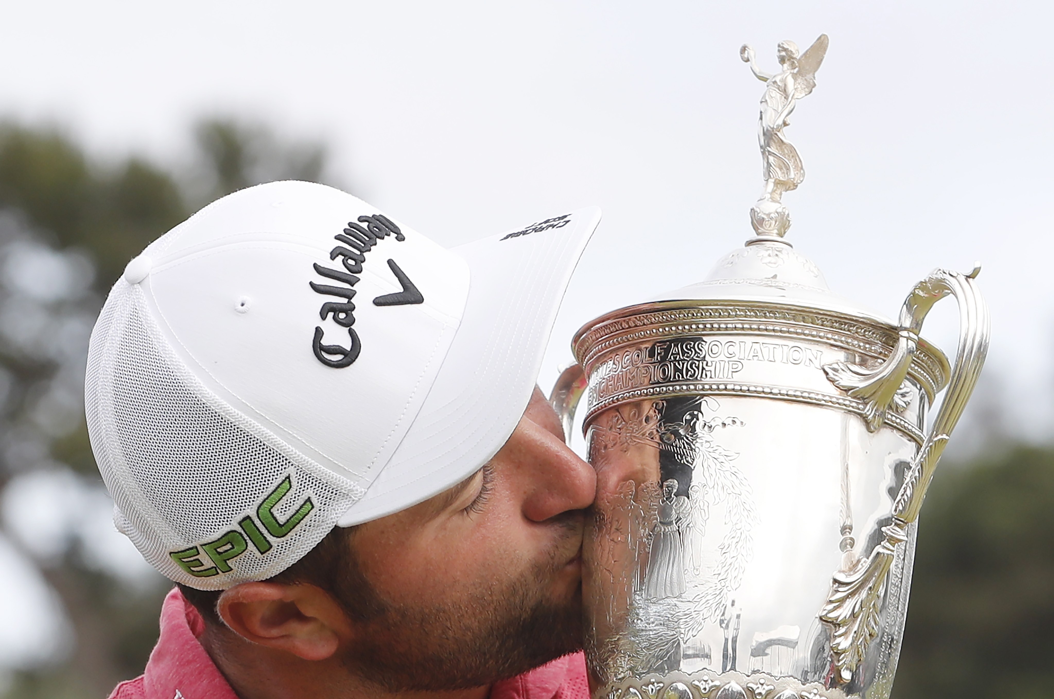 Jon Rahm celebrates his first major win with the US Open Championship Trophy after winning at Torrey Pines. Photo: EPA
