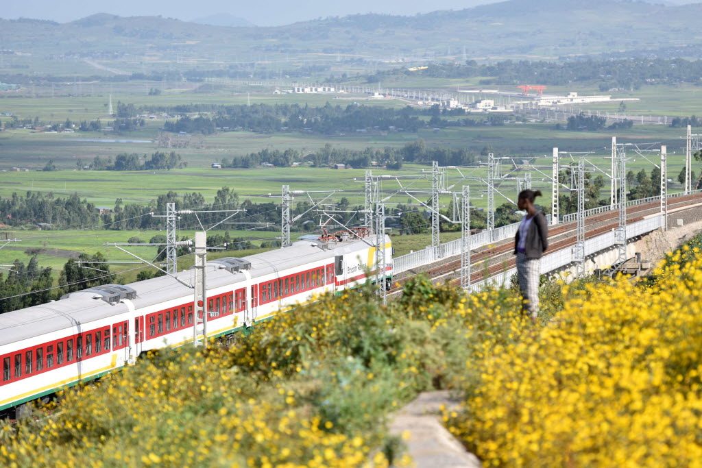 A person watches a train on the Ethiopia-Djibouti railway, Africa’s first modern electrified railway, during an operational test near Addis Ababa, Ethiopia, on October 3, 2016. It was built by Chinese firms. Photo: Xinhua