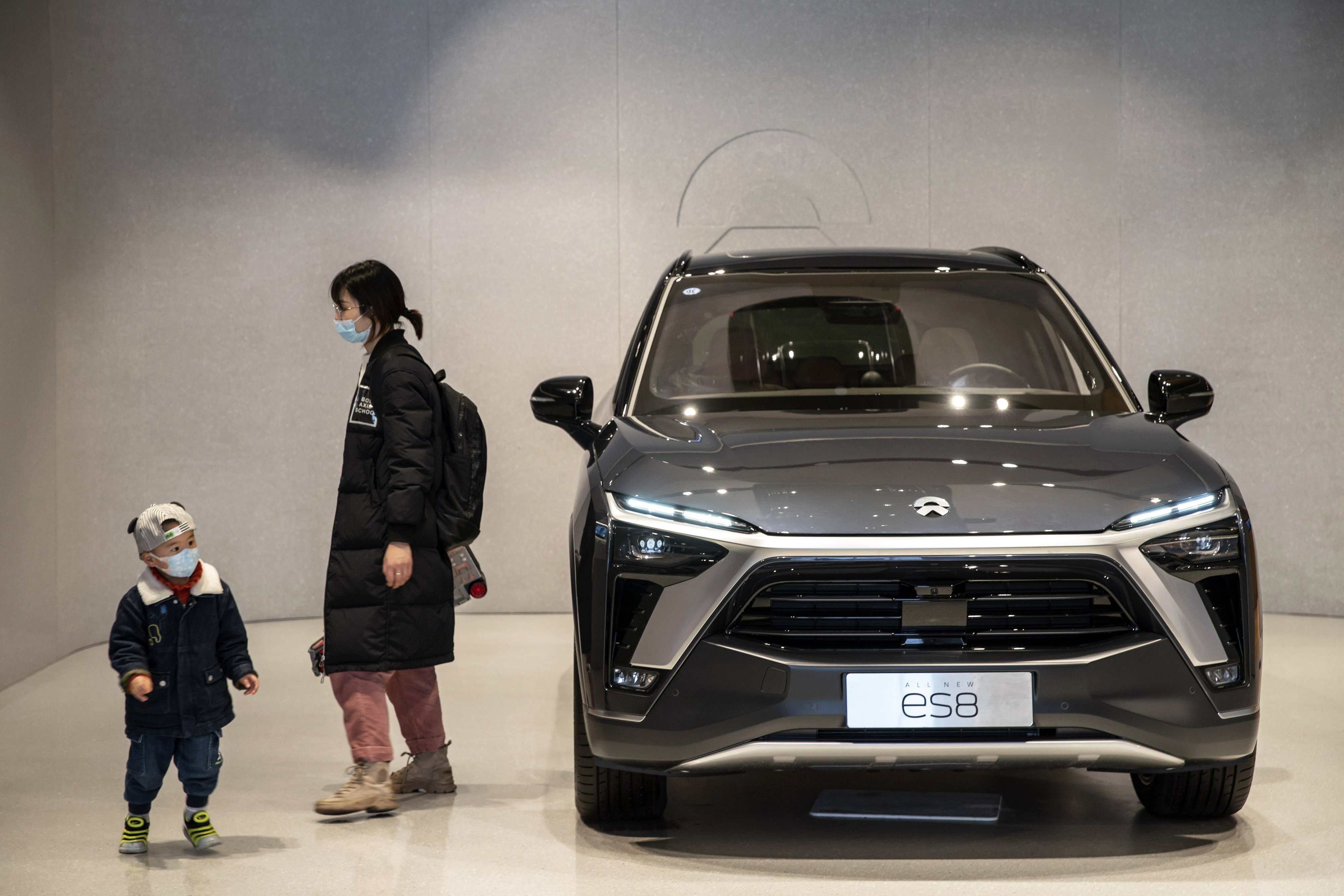 A child eyes up a NIO ES8 electric vehicle at a NIO House in Shanghai. Photo: Bloomberg