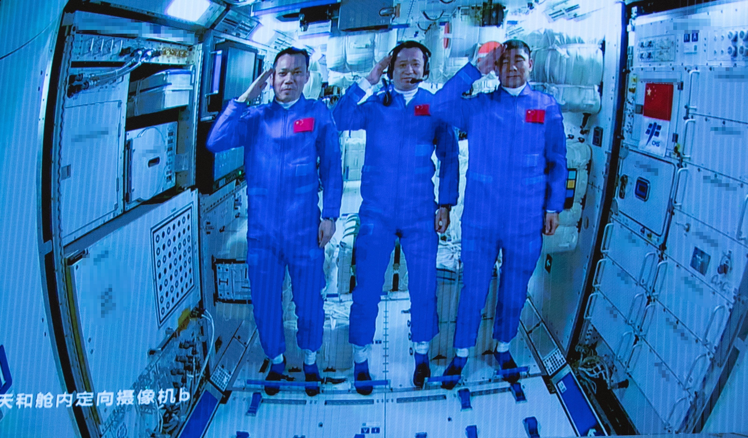 Three Chinese astronauts onboard the Shenzhou-12 spaceship salute after entering the Tianhe space station core module on June 17, 2021. Photo: EPA-EFE
