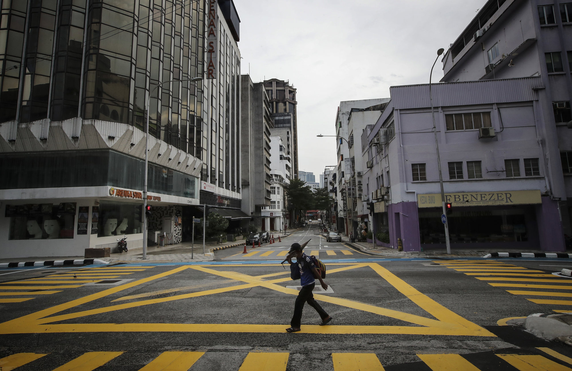 A man walks along a deserted street in Kuala Lumpur during a nationwide lockdown imposed by the Malaysian government following a surge of Covid-19 cases. Photo: DPA