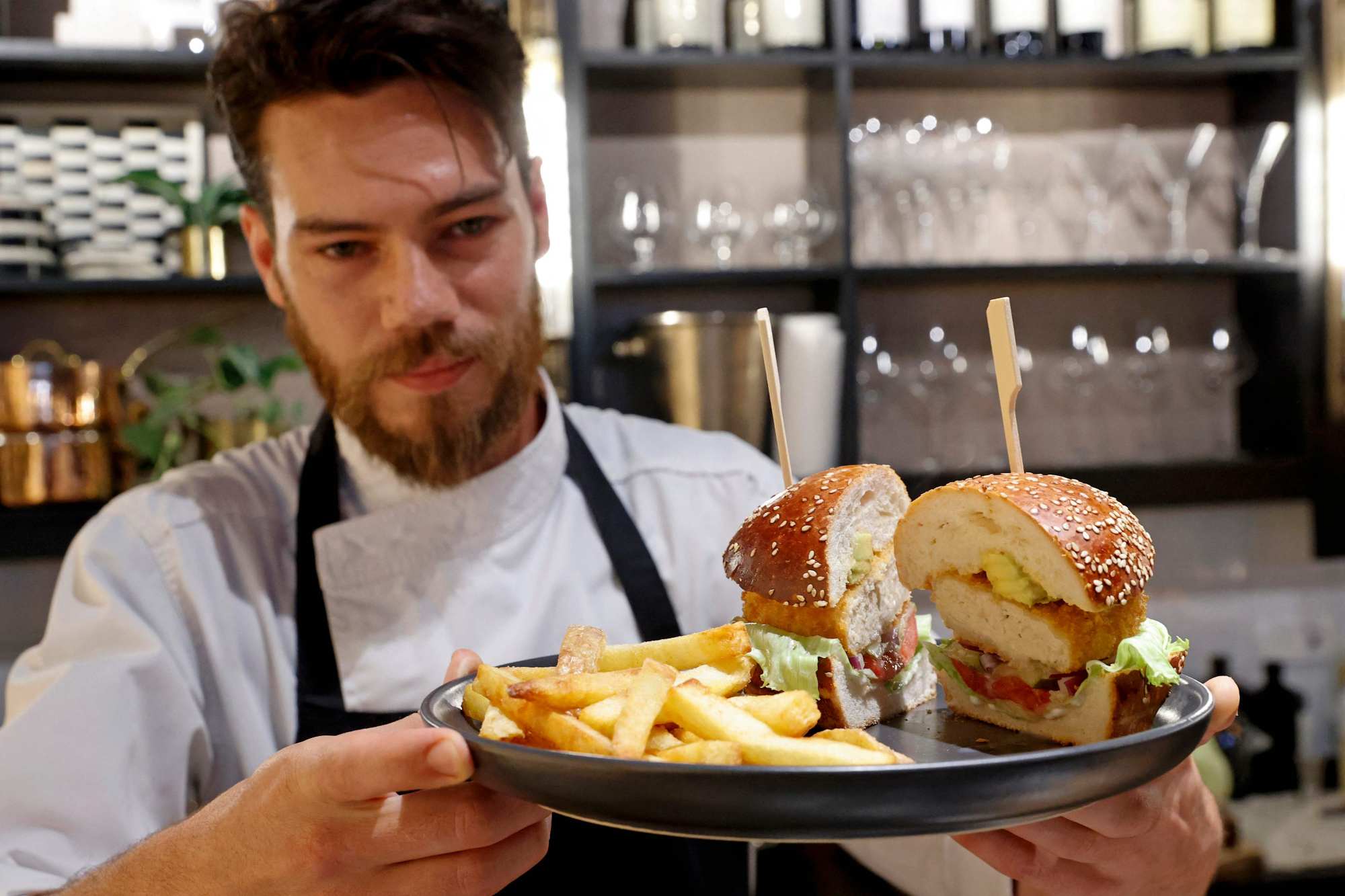 Chef Shachar Yogev serves a burger made with ‘cultured chicken’ meat. Photo: Jack Guez/AFP