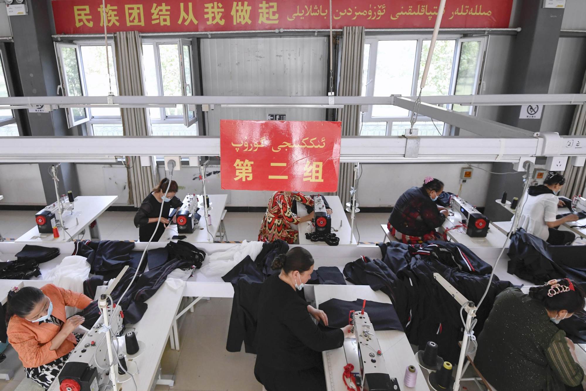 Members of the Uygur ethnic minority work at a sewing factory in Kashgar in China’s Xinjiang autonomous region on May 11.