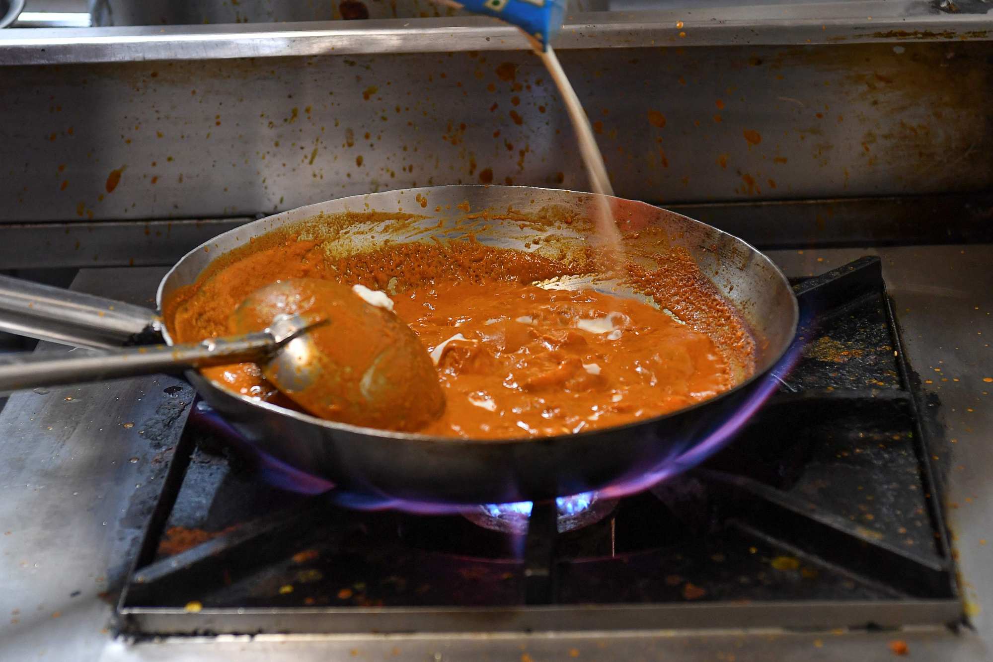 Goila prepares a dish in the kitchen of his Goila Butter Chicken restaurant in Mumbai. Photo: AFP