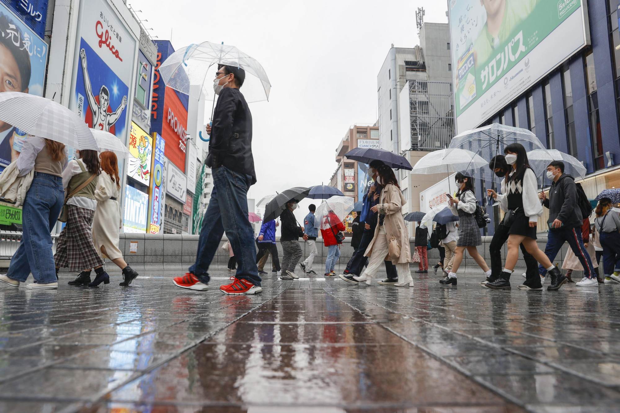 Pedestrians brave a rainy day in Osaka on April 4. The city was the world’s 15th-most-widely-traded property market in the first quarter. Photo: Kyodo