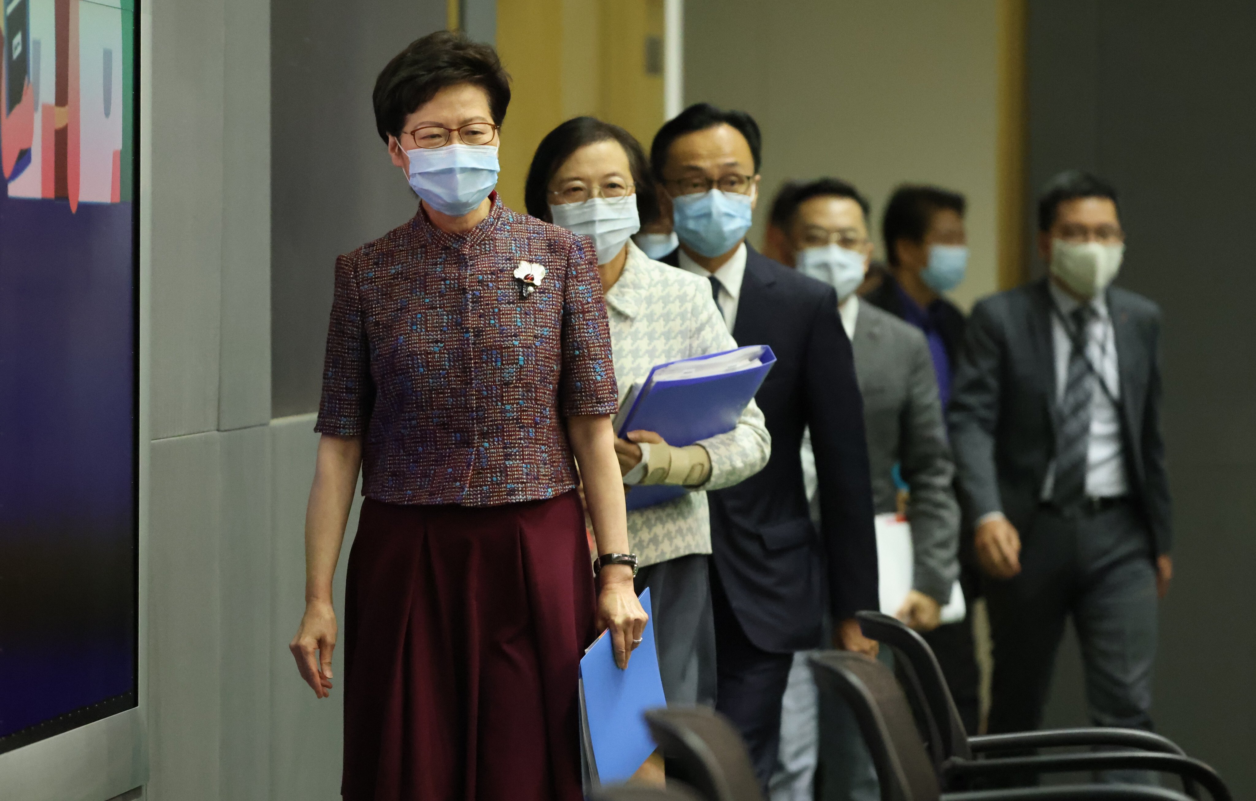 Chief Executive Carrie Lam, followed by Secretary for Food and Health Sophia Chan and Secretary for the Civil Service Patrick Nip Tak-kuen, walks into a press conference at the government headquarters in Admiralty on June 21. Photo: Nora Tam
