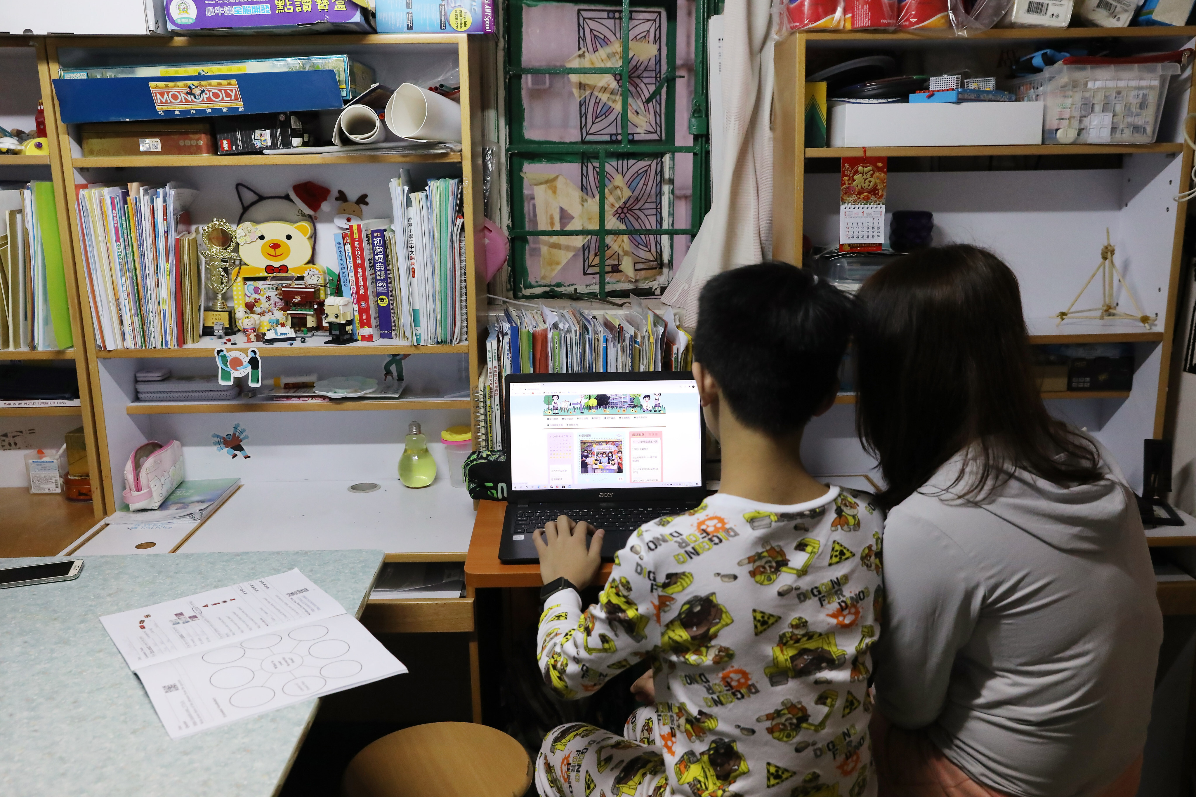 A student looks at an online portal in Sham Shui Po on December 22, 2020. Students from disadvantaged backgrounds have struggled with the move to online learning. Photo: K. Y. Cheng