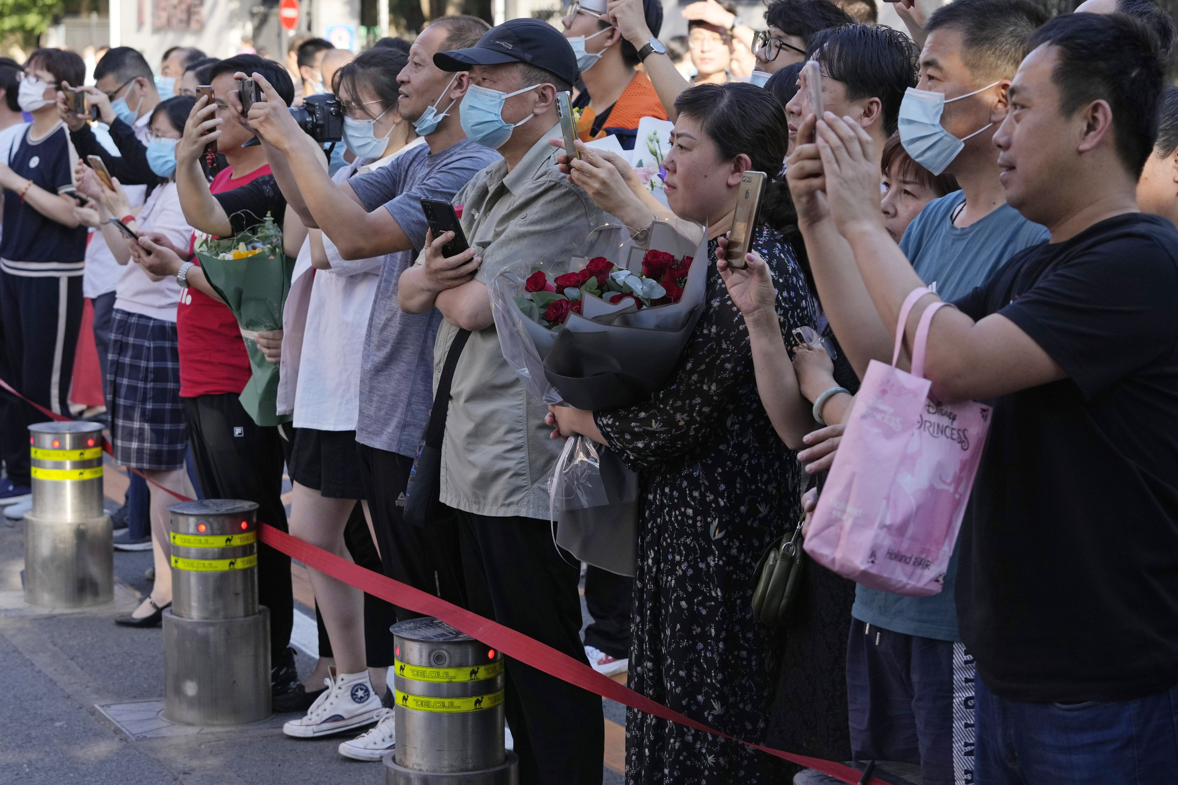 Family members wait for students to finish the final day of China’s national college entrance examinations, known as the gaokao, in Beijing on June 10. Photo: AP