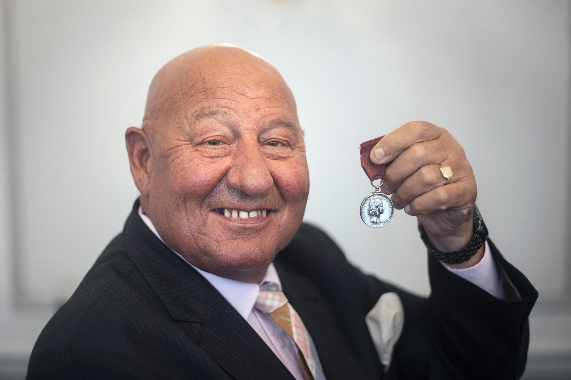 Former heavyweight boxer Ronnie Russell poses with the George Medal he was awarded for saving Princess Anne from a kidnap attempt in 1974, ahead of it being auctioned at Dix Noonan Webb in London. Photo: PA Images via Getty Images