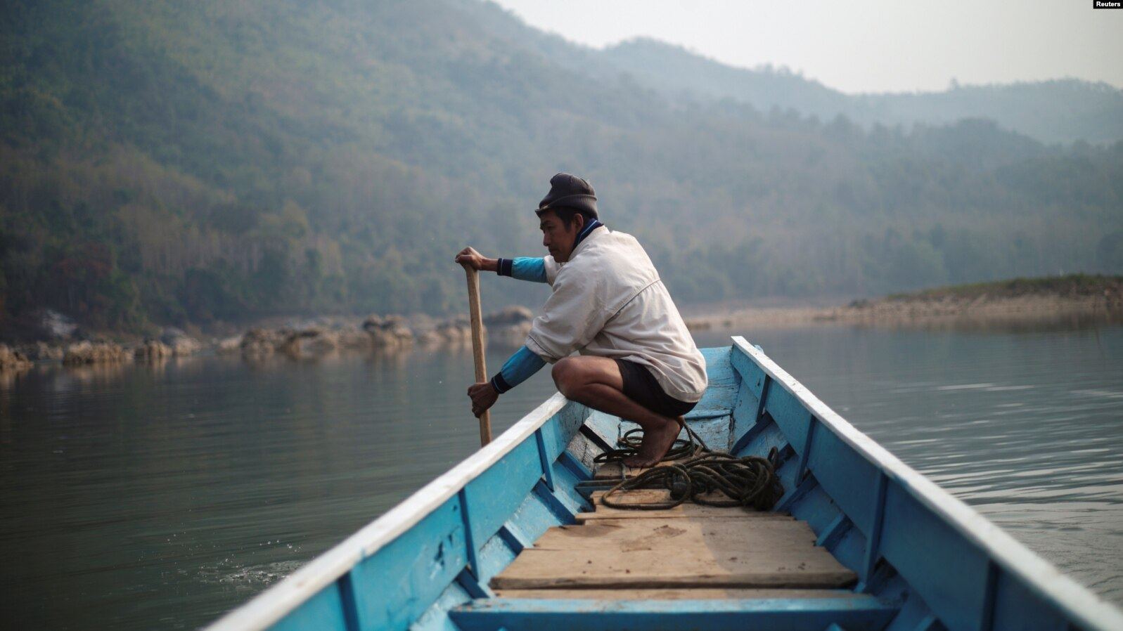 A local villager drives a boat where the future site of the Luang Prabang dam will be on the Mekong River, on the outskirts  of Luang Prabang province, Laos, on February 5 last year. Photo: Reuters