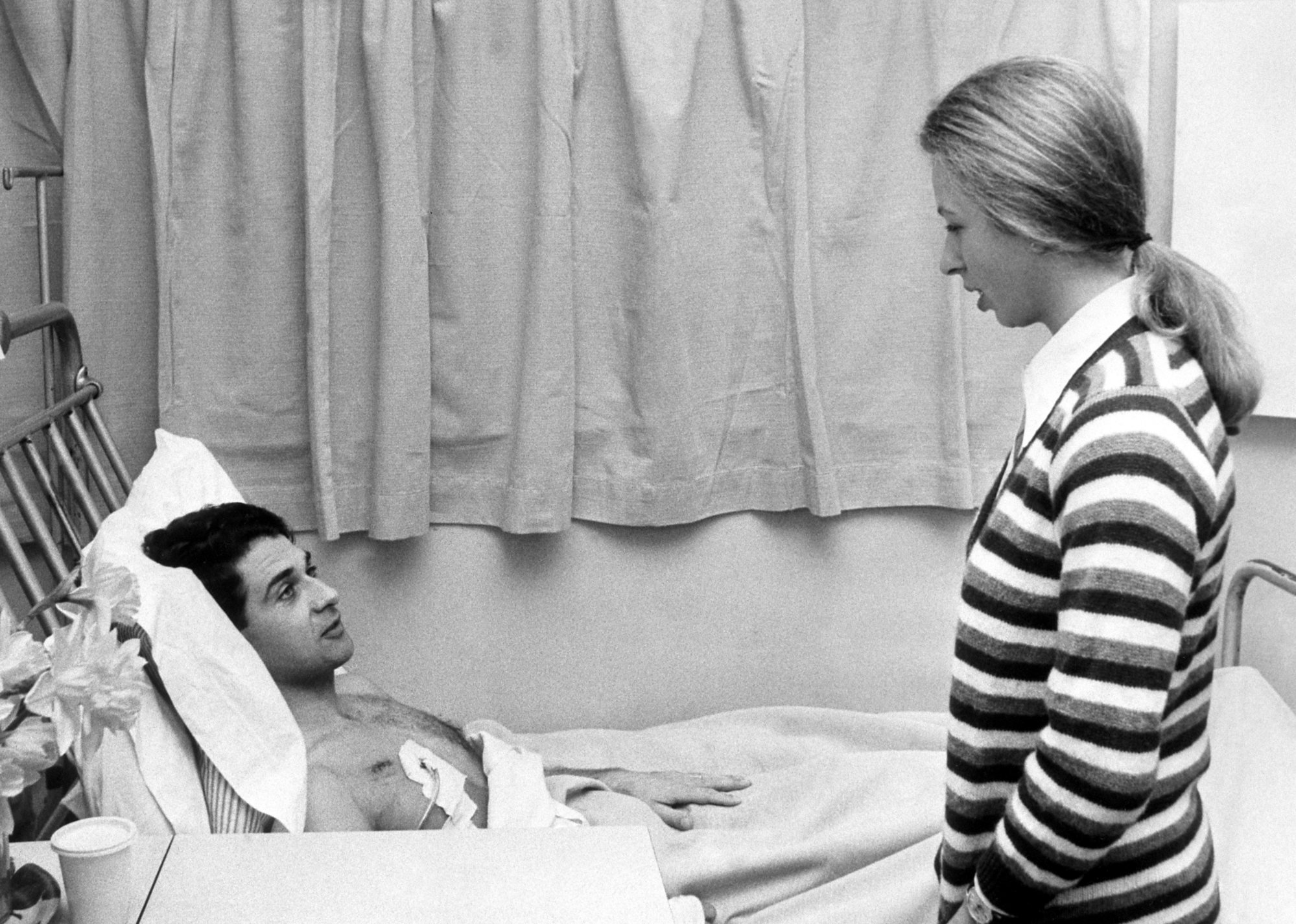 Princess Anne chats to her wounded bodyguard, Inspector James Beaton, at Westminster Hospital in 1974. Photo: PA Images via Getty Images