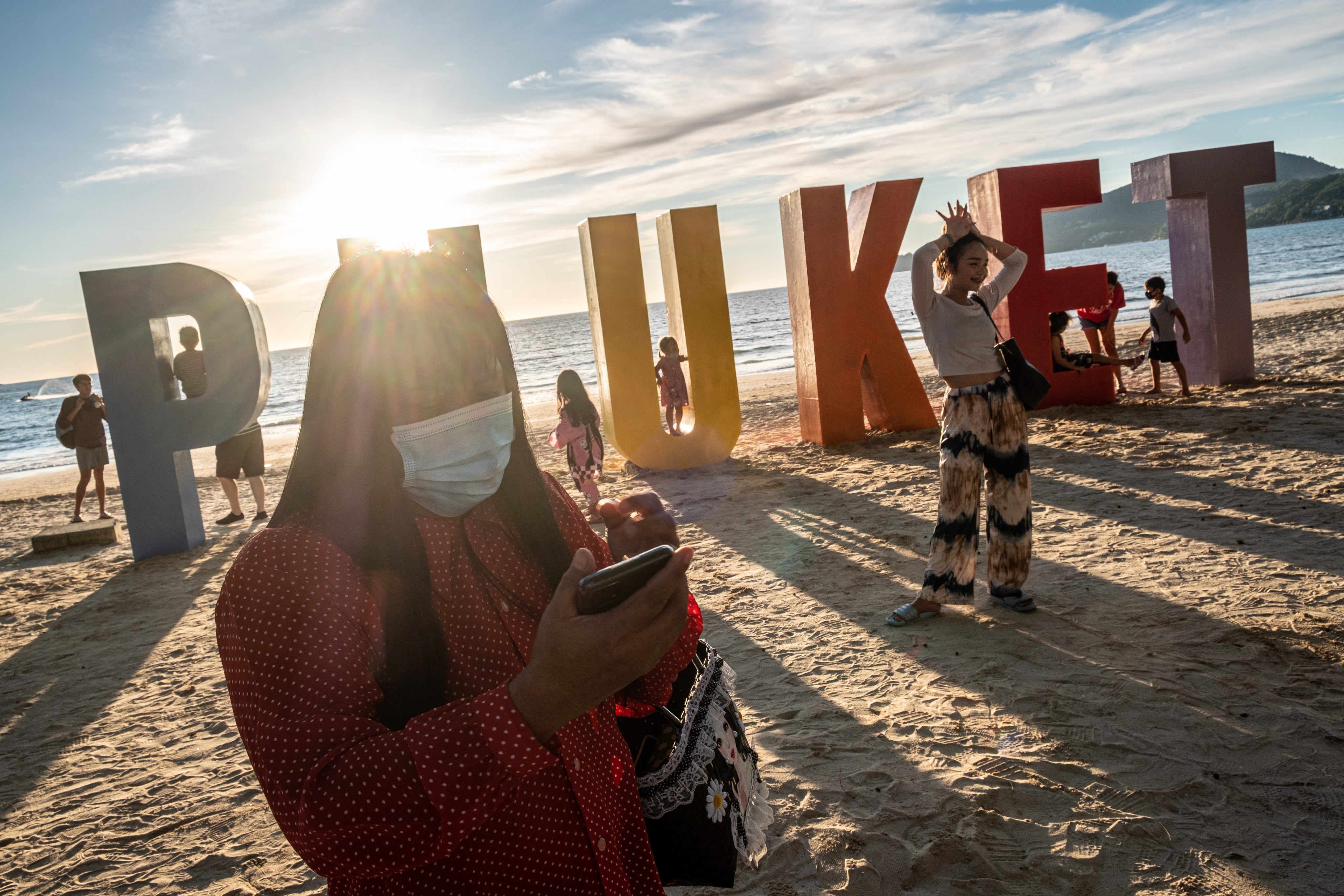 Locals and tourists attend an event organised to mark the opening of Phuket to international tourists on Patong beach. What will it take for Bali in Indonesia, which has seen day after day of record-breaking new case numbers, to reopen? Photo: Getty Images