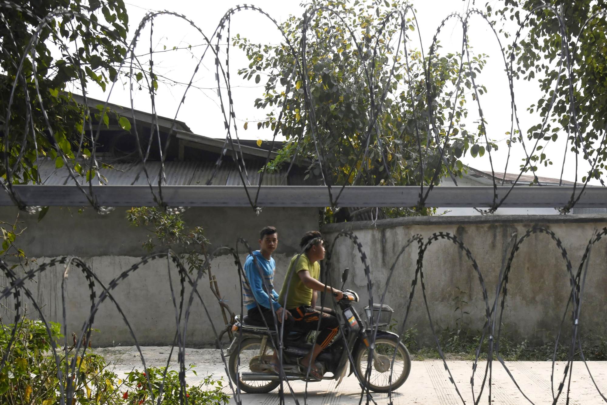 Two motorists in Myanmar are seen in this photo taken from the Chinese border. Photo: Kyodo