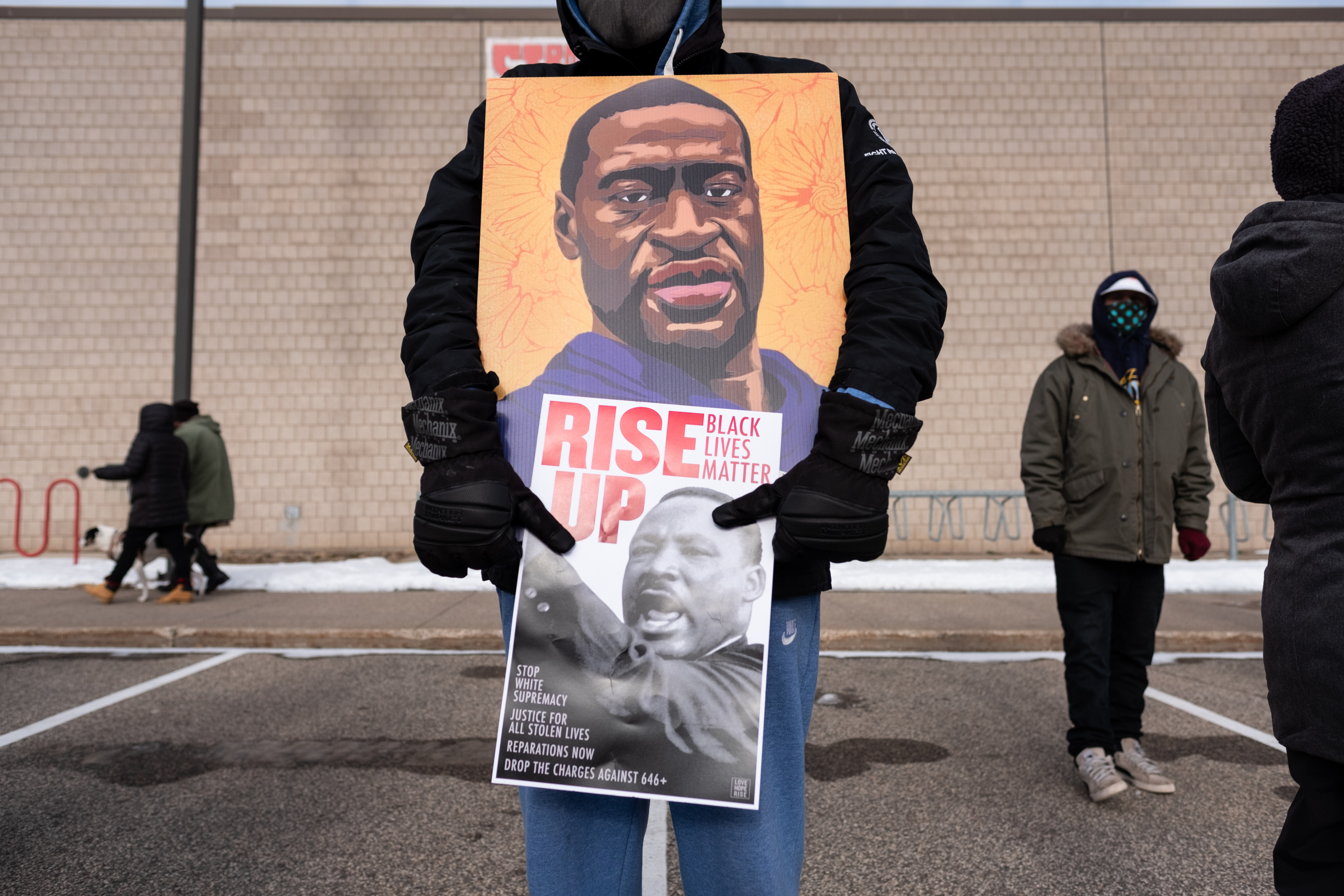 A protester holds a poster of George Floyd during a rally in St. Paul on Martin Luther King Jr. Day. January 18, 2021. Photo by Tim Evans/NurPhoto via Getty Images