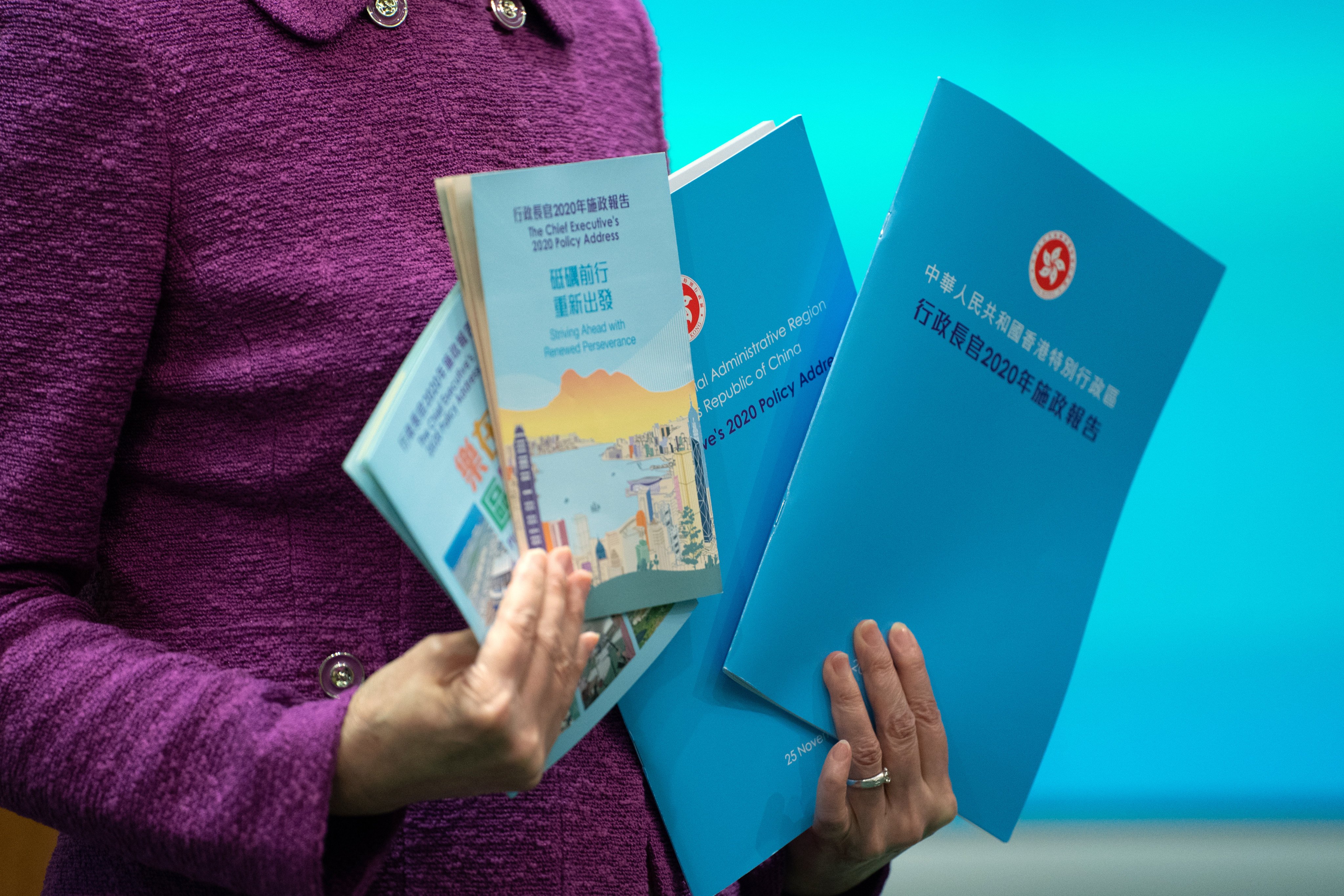 Carrie Lam, Hong Kong’s chief executive, poses with copies of her 2020 policy address on November 25. Photo: Bloomberg