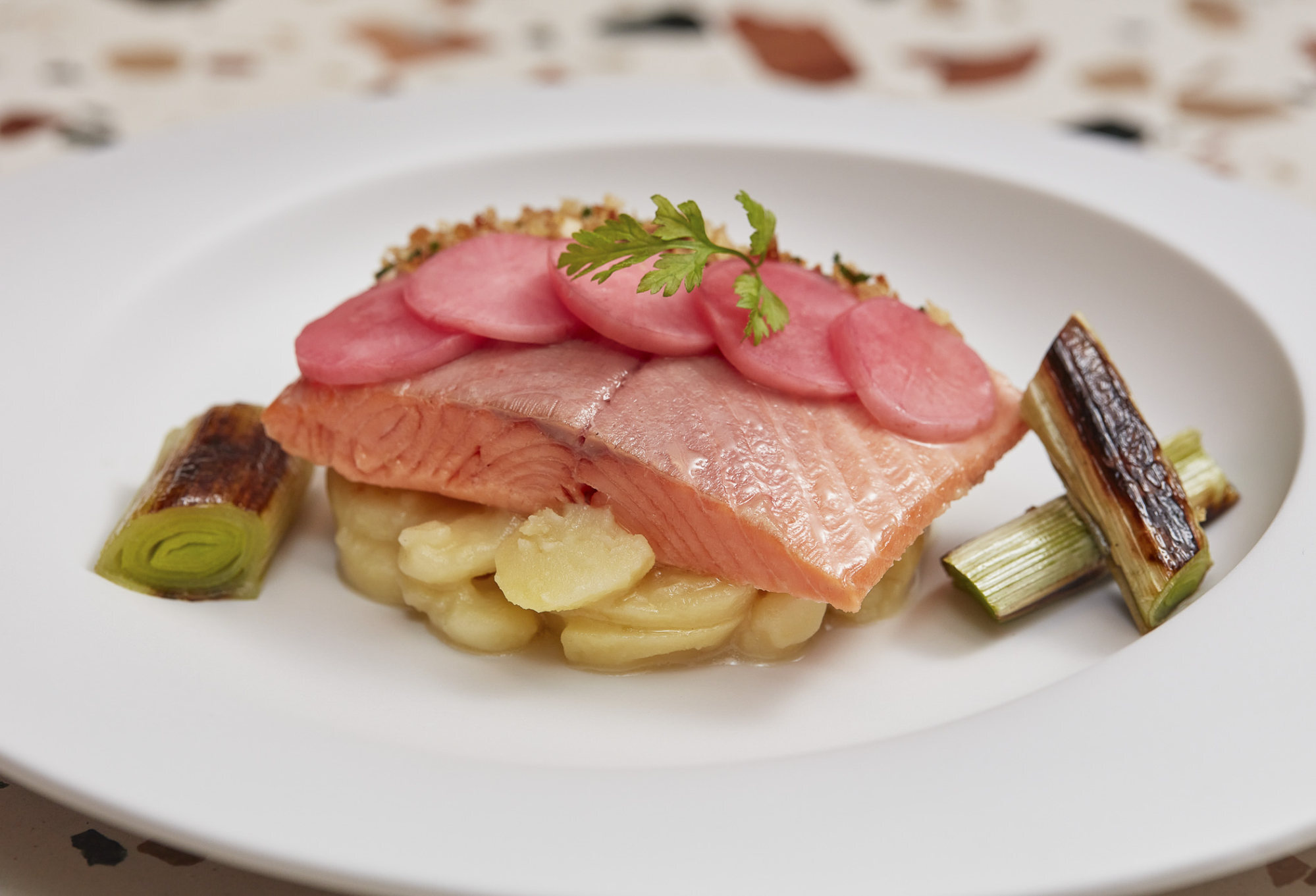 Rainbow trout confit with potato salad, grilled leek and pickled radish at Margo.