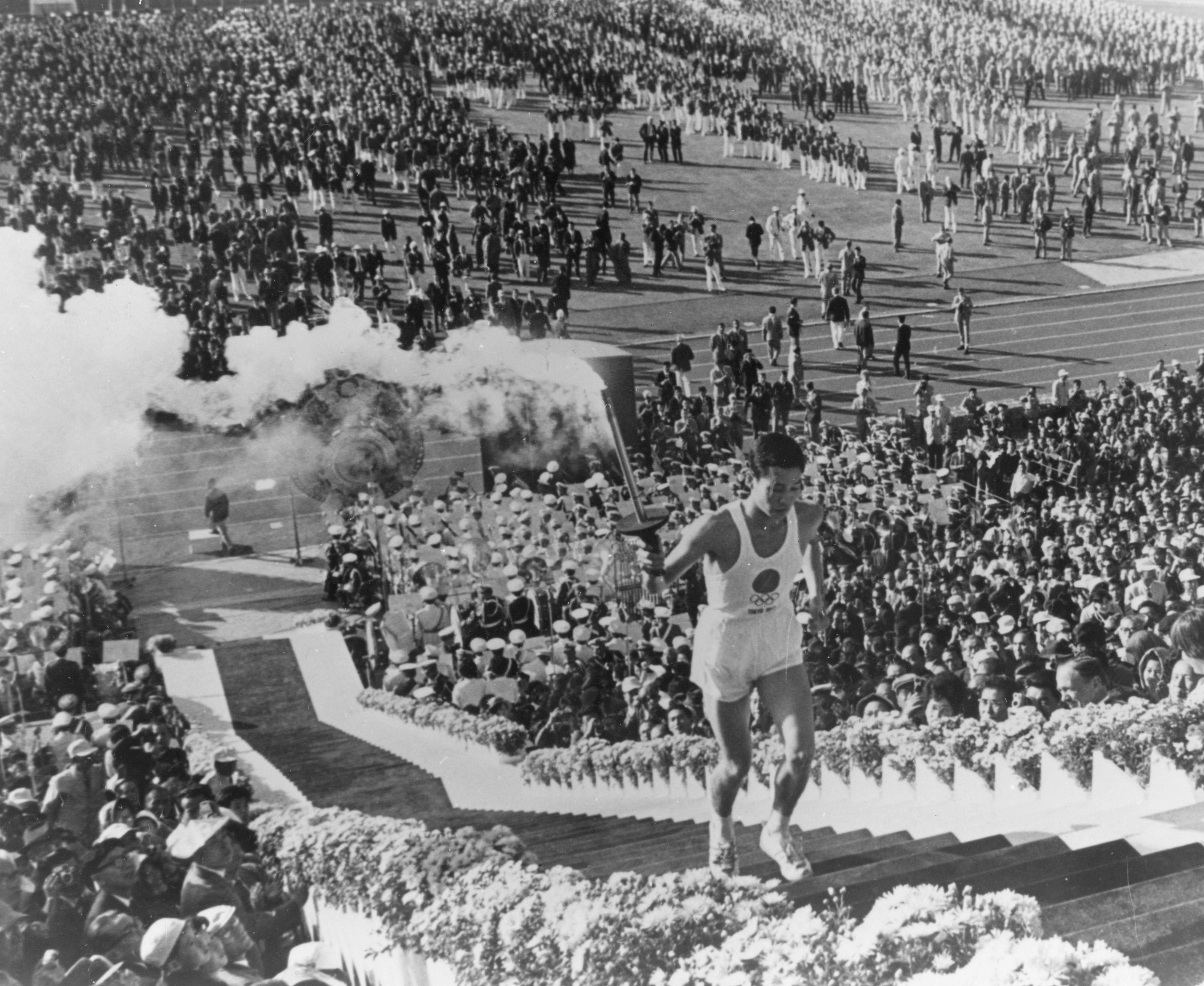 Yoshinori Sakai, a student born in Hiroshima on the day the first atomic bomb devastated the city, during the opening ceremony for the 1964 Tokyo Olympics. Photo: Getty Images