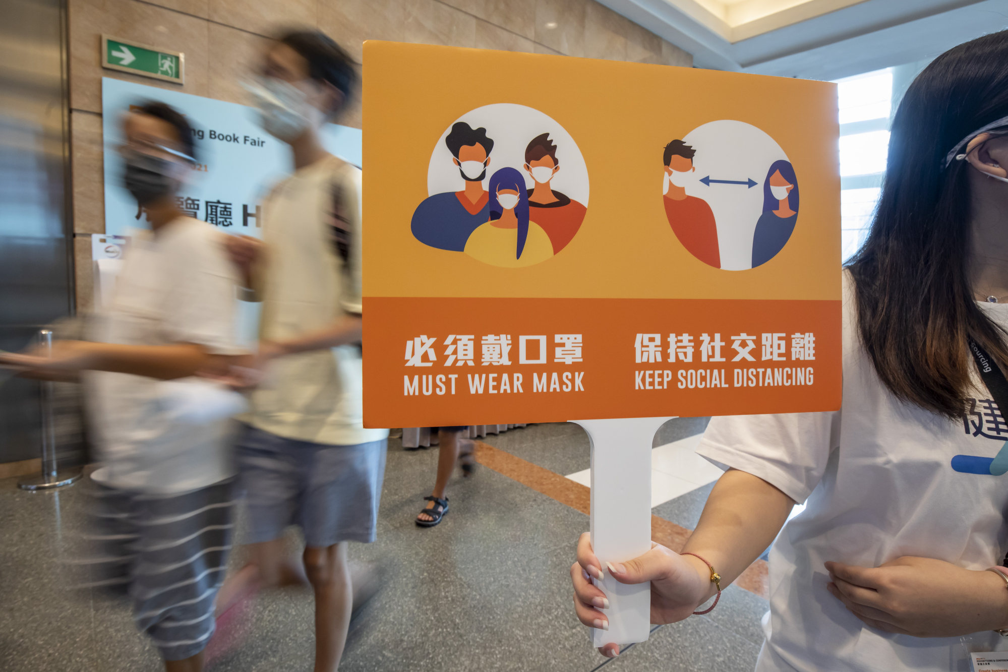 A sign reminds visitors to observe social distancing measures at this year’s Hong Kong Book Fair, held amid the Covid-19 pandemic, on July 14. Photo: Bloomberg