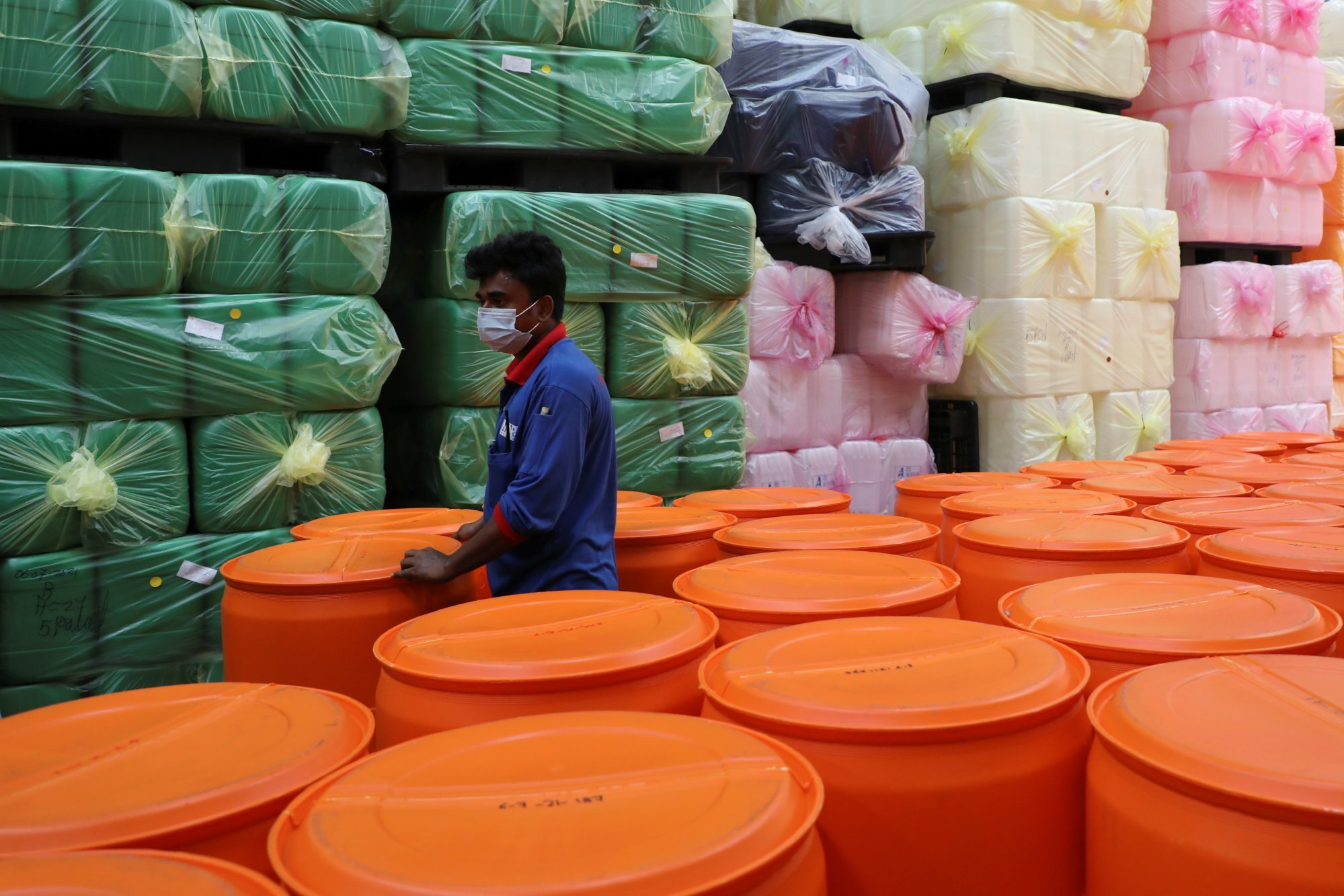 A worker at a plastic containers factory in Pulau Indah, Malaysia. Photo: Reuters