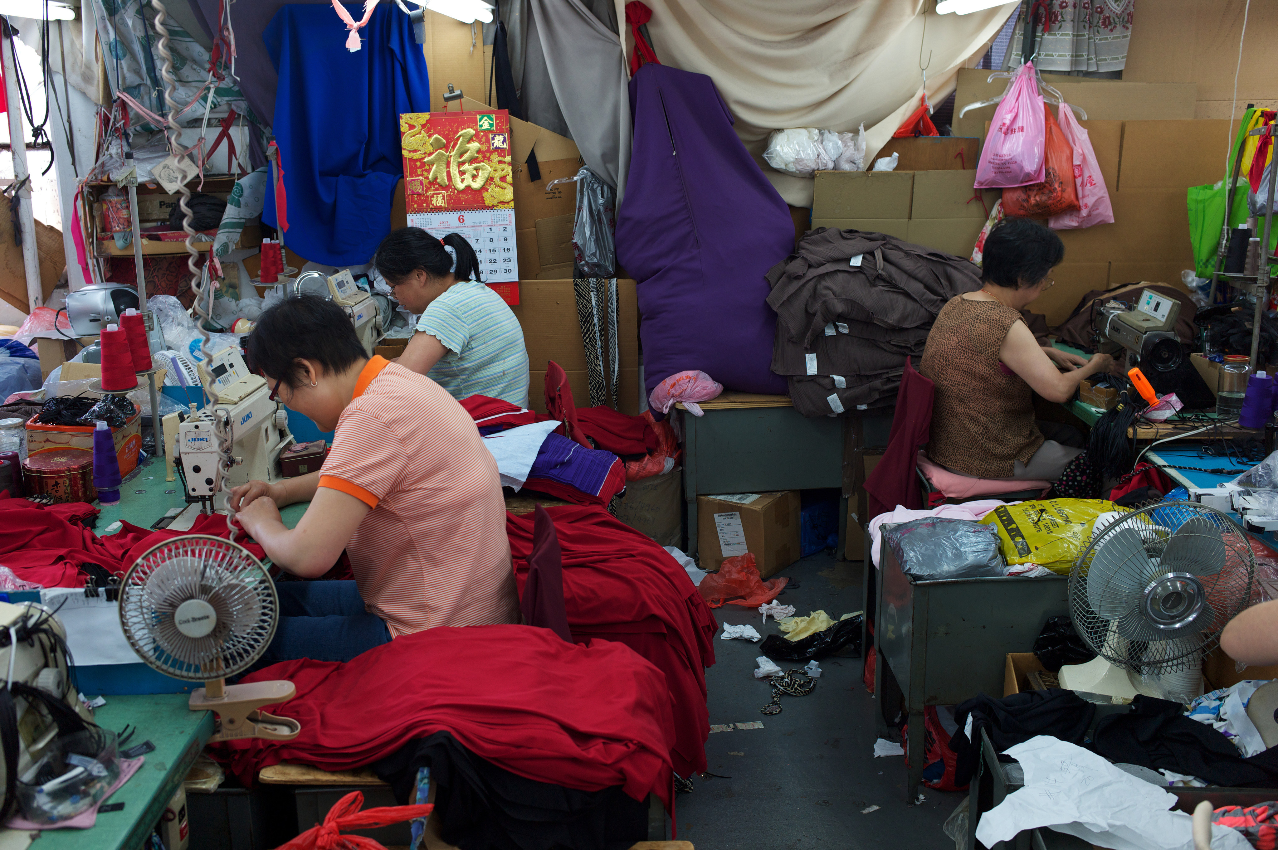 Women work in a sweatshop in Brooklyn, New York. Anna Qu, author of Made in China, was sent to work in one her mother and stepfather owned at the age of 15. Photo: Andrew Lichtenstein/Corbis via Getty Images