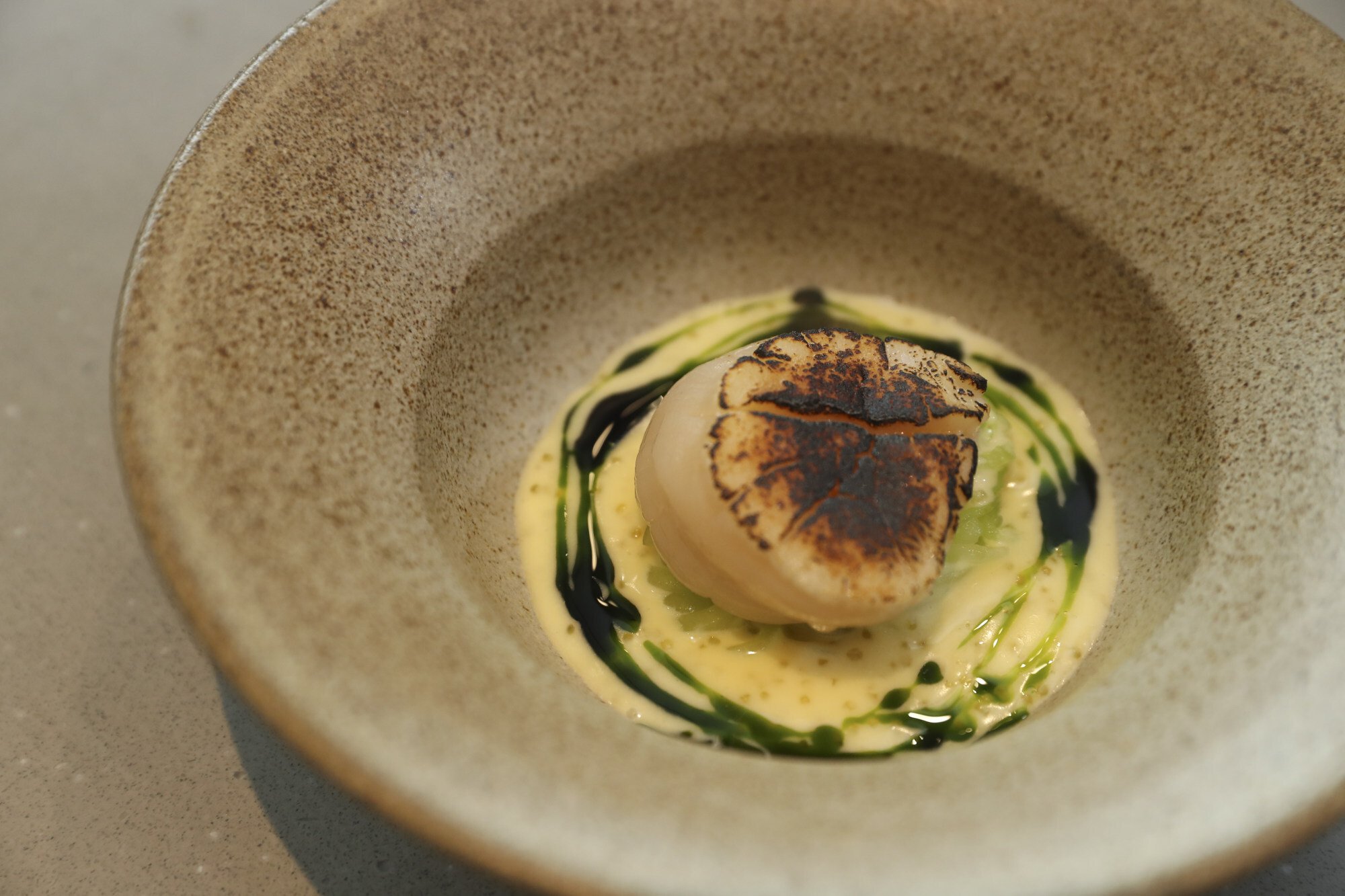 The finished dish of scallop, celtuce, with pike, perch roe at Aulis. Photo: Edmond So