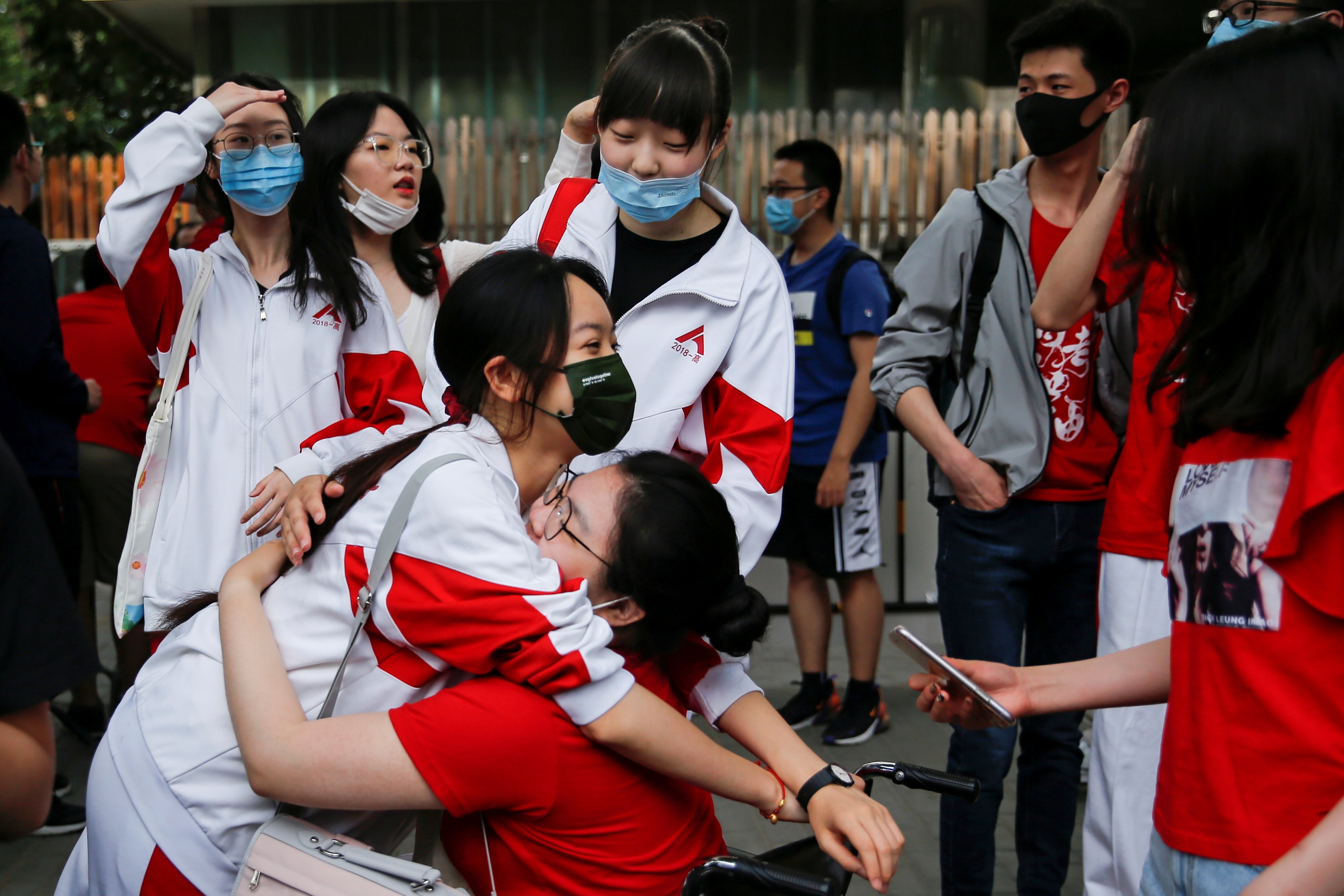 A student hugs her friend before the gaokao, the annual national university admissions exam, in Beijing on June 7. In China, inclusive institutions allow ordinary Chinese to believe that they can earn a good living and move up the social ladder if they study and work hard. Photo: Reuters 