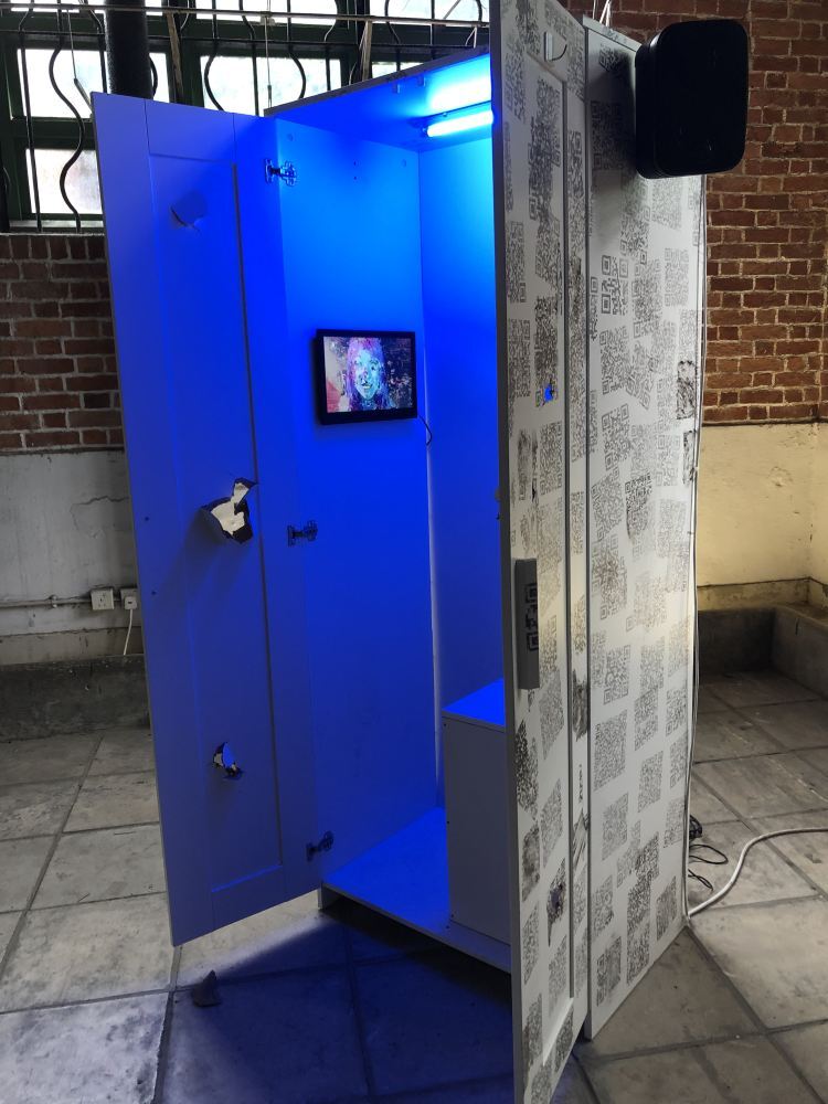 A wardrobe in which imaginary “signals from the future” are received by us today. A video warning of a future in which all land is submerged in water, by the artist Betty Apple, plays inside. Photo: Enid Tsui