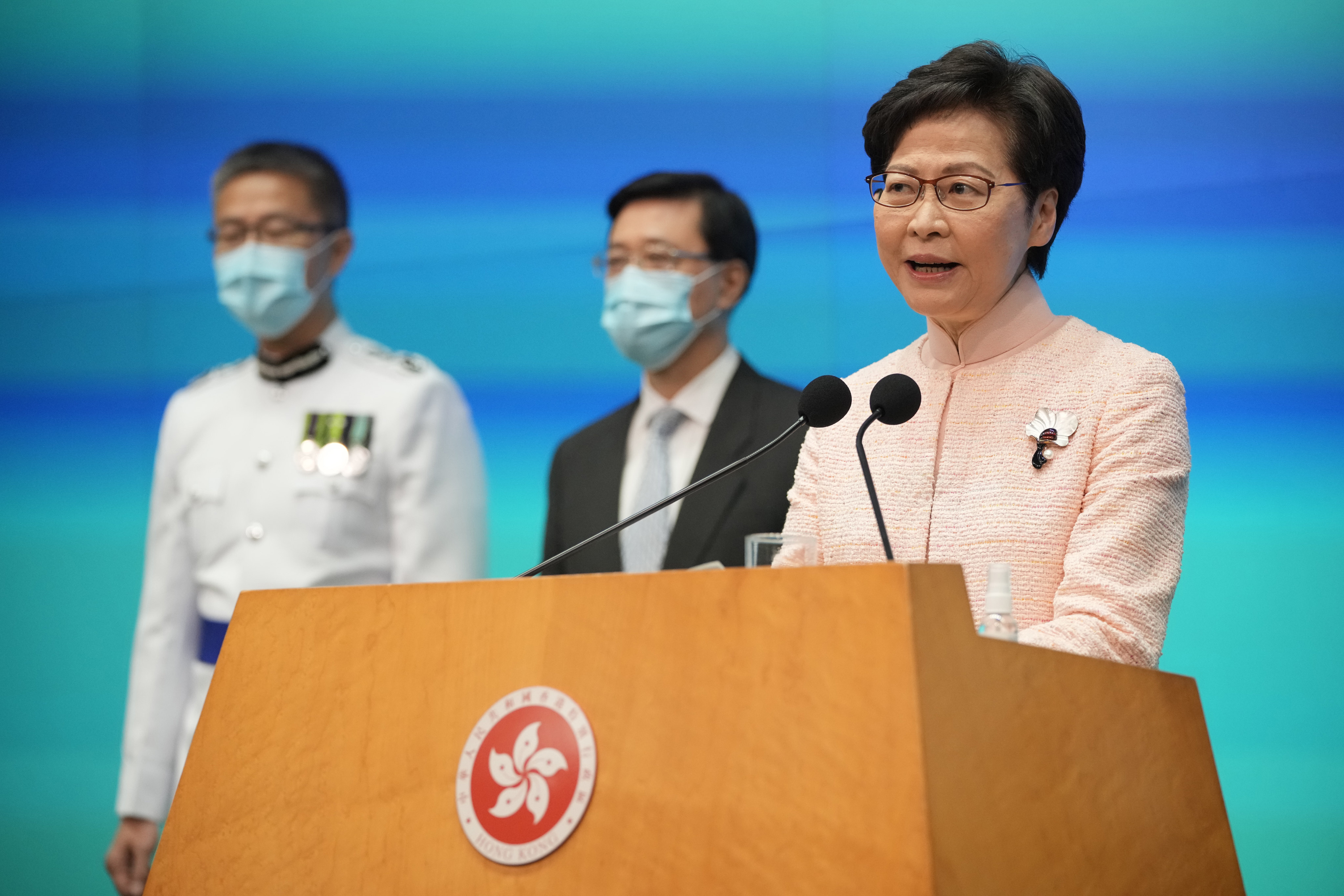 Chief Executive Carrie Lam (right) is flanked by Chief Secretary John Lee (centre) and Commissioner of Police Raymond Siu at a press conference on June 25. Photo: AP 