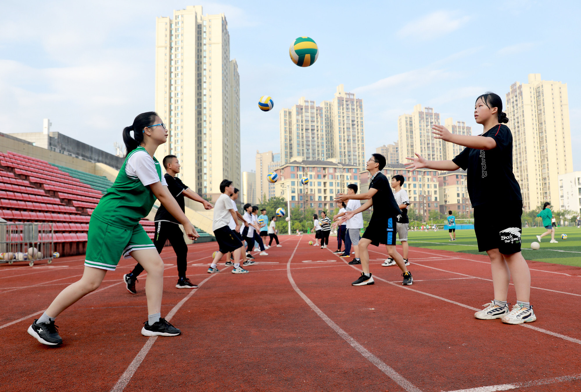 Students play volleyball during a summer programme in Huaying city, Sichuan province. Low fertility rates have made reducing the cost of raising children a priority for Beijing, in the interest of China’s long-term development. Photo: Xinhua