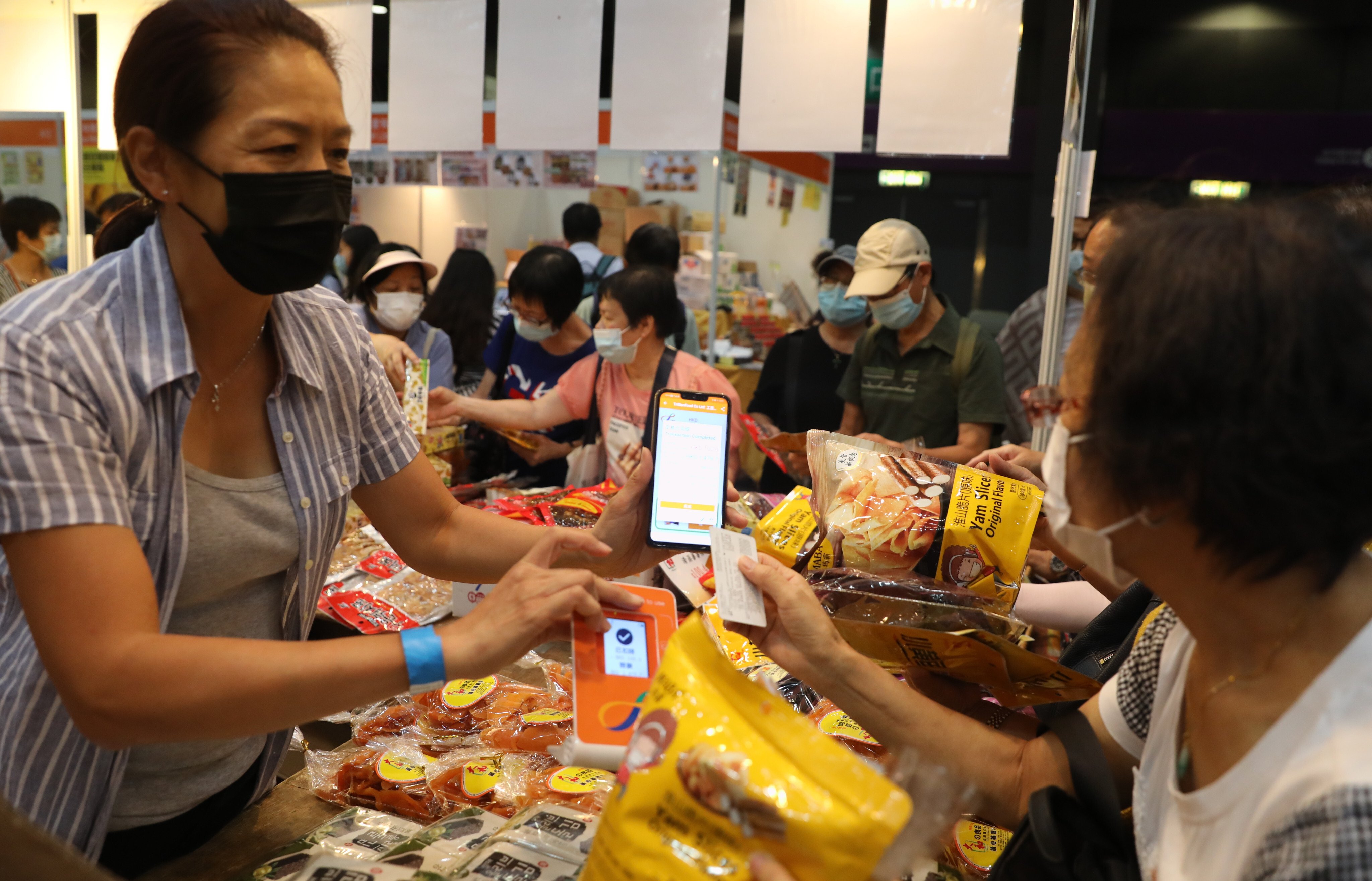 Visitors to the Hong Kong Brands and Products Shopping Expo, at Asia World Expo, make purchases with their digital shopping vouchers on August 7. Photo: Winson Wong