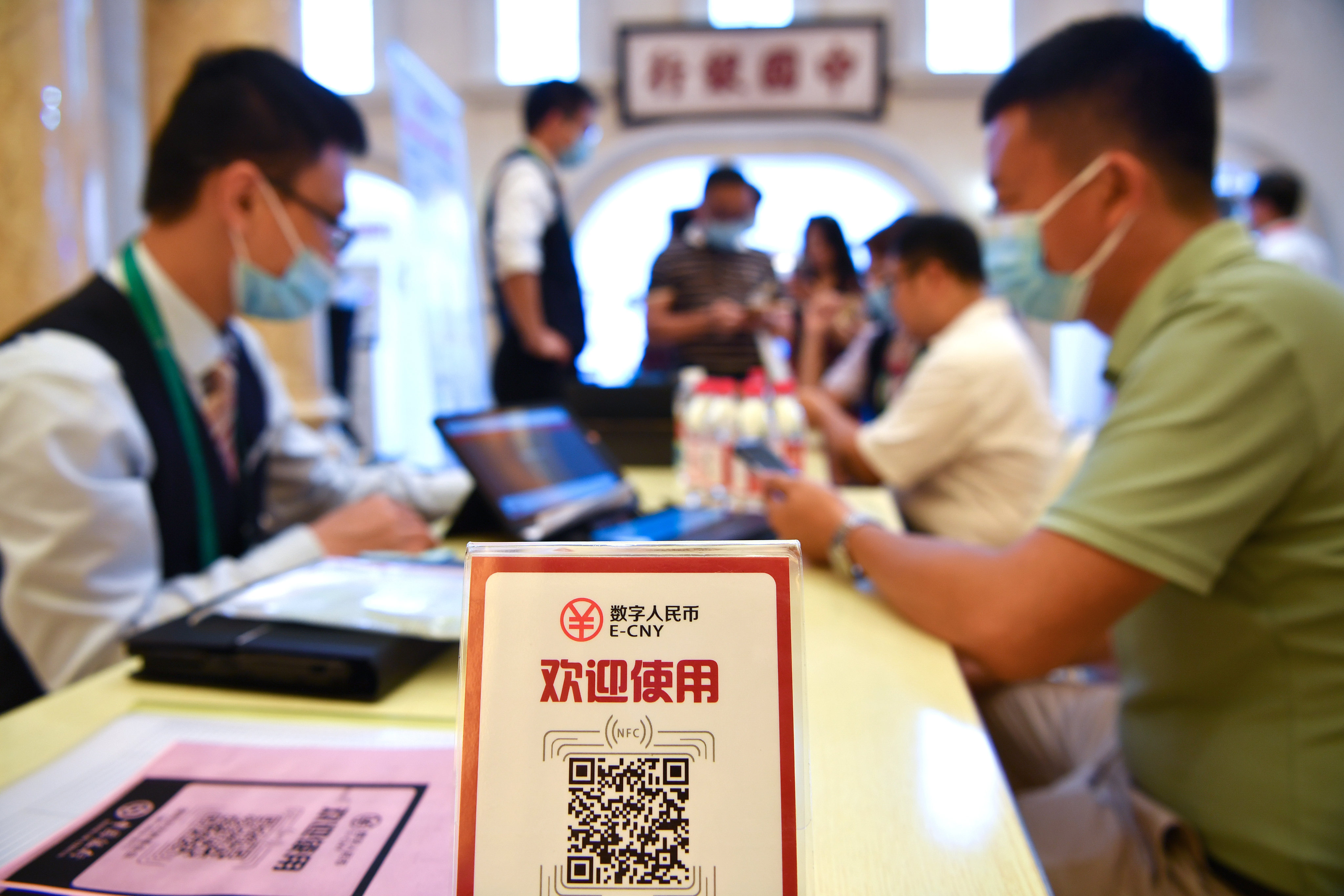 A man signs up to pay with the e-yuan, China’s digital currency, at an expo in Hainan on May 8. Photo: Xinhua