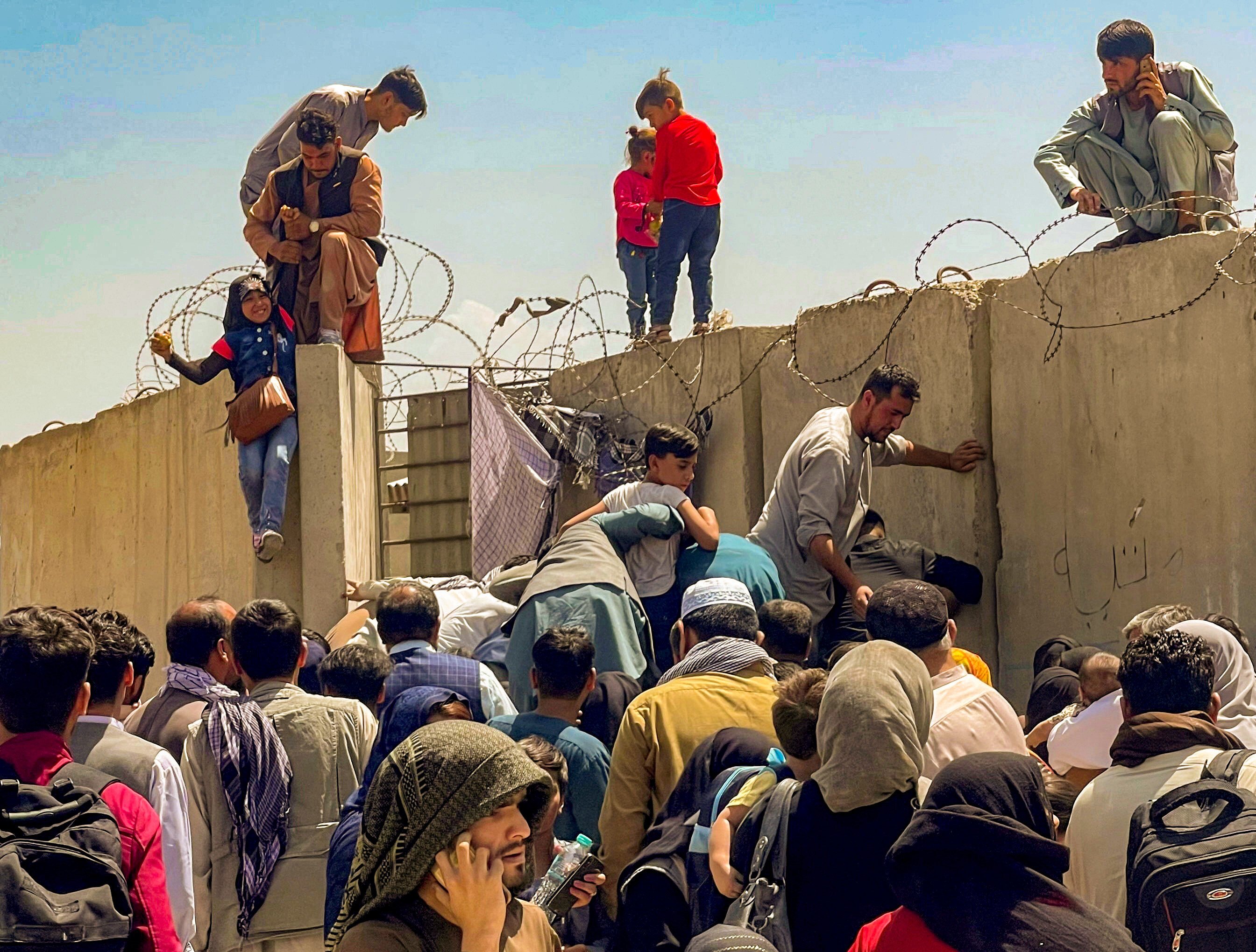 People try to get into Hamid Karzai International Airport in Kabul, Afghanistan, on Monday to escape Taliban rule, as the US military pulls out. Photo: Reuters