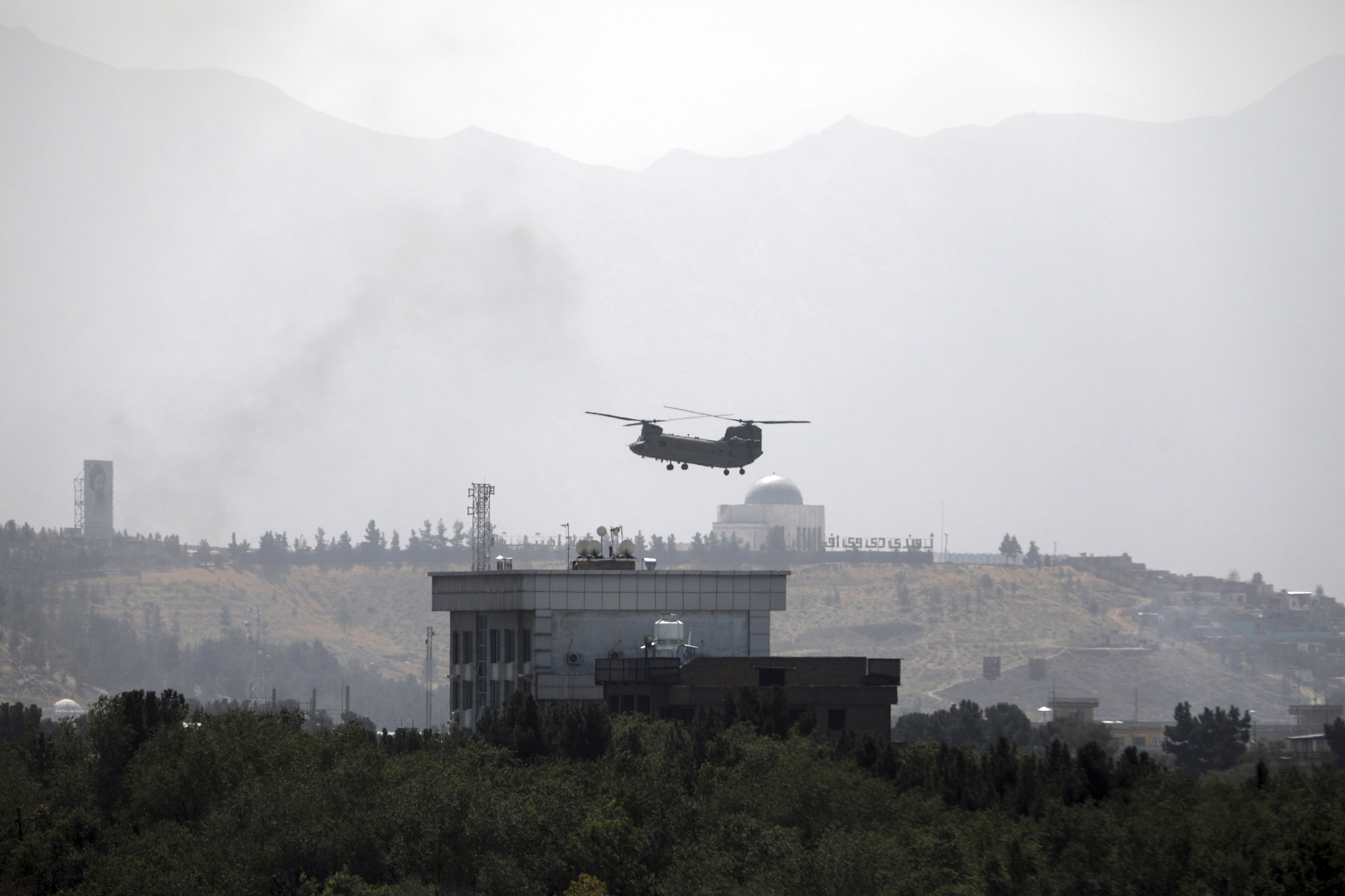 A US Chinook helicopter flies over the US Embassy in Kabul, Afghanistan during the Taliban’s advance. Photo: AP