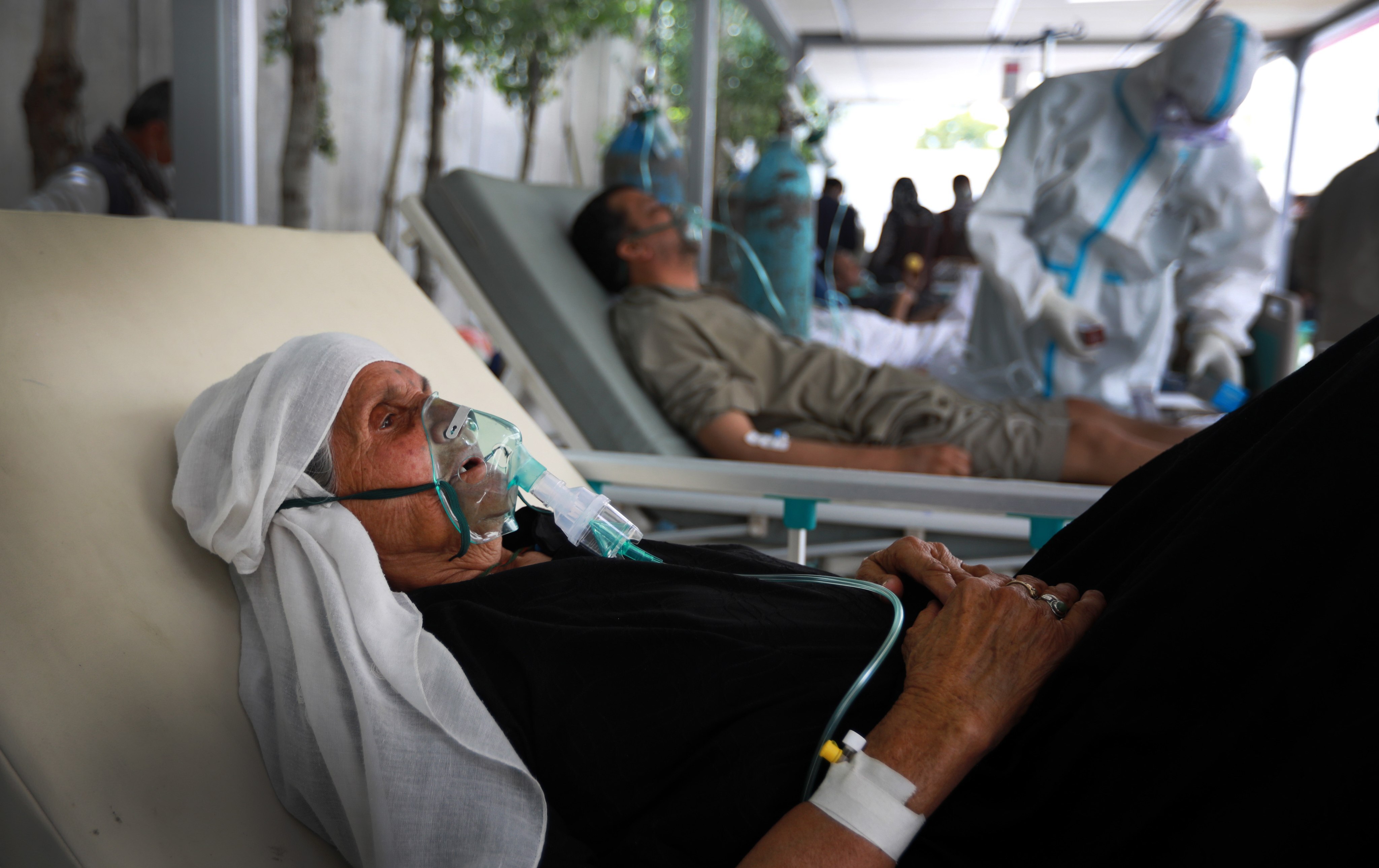 An Afghan woman breathes through an oxygen mask in a special hospital for Covid-19 patients in Kabul on June 9, 2020. Less than 2 per cent of Afghanistan’s population has received at least one vaccine dose, with only 0.5 per cent being fully vaccinated. Photo: EPA-EFE